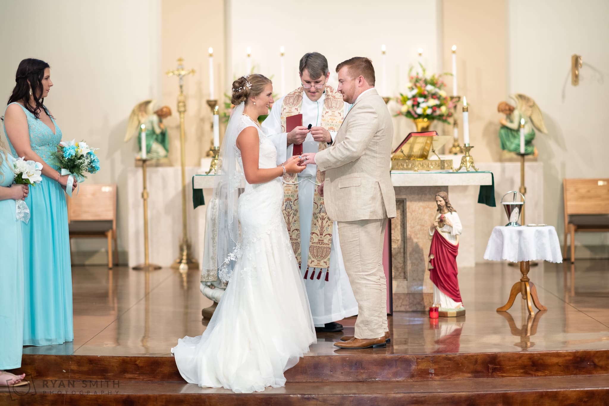 Putting on the groom's ring - St. Michael's - Garden City, SC