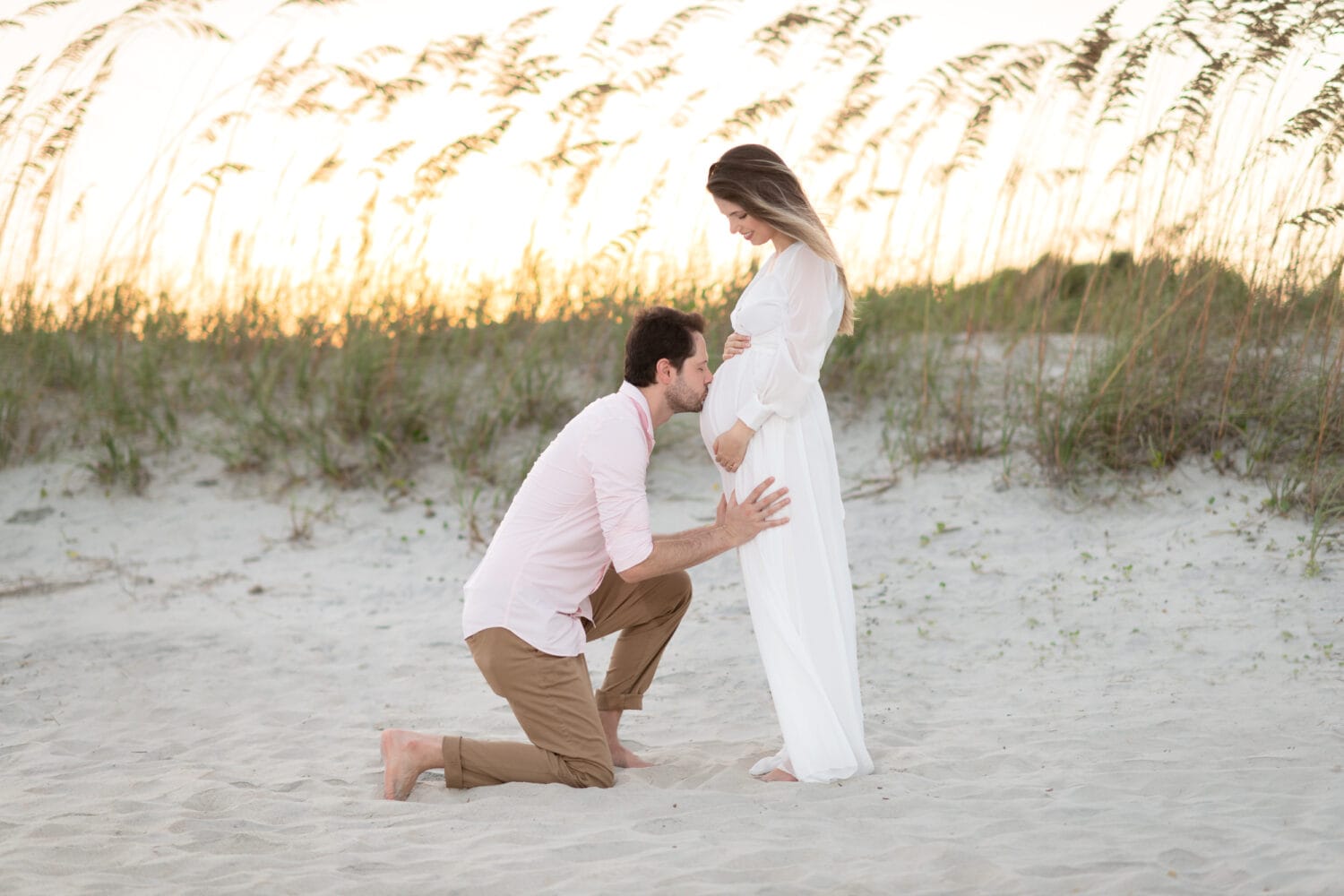 Maternity portrait - husband kissing wife on the belly - Huntington Beach State Park