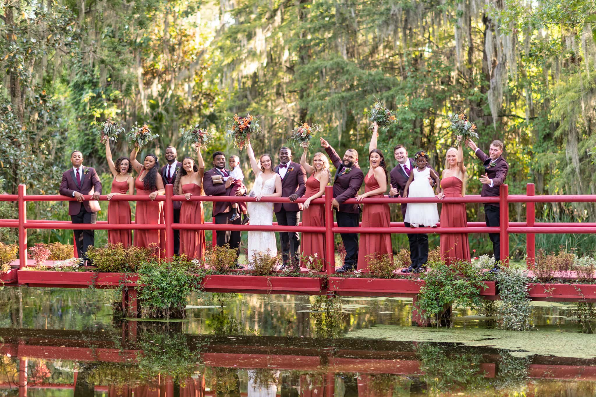 Bridal party cheering on red bridge  - Magnolia Plantation - Charleston, SC