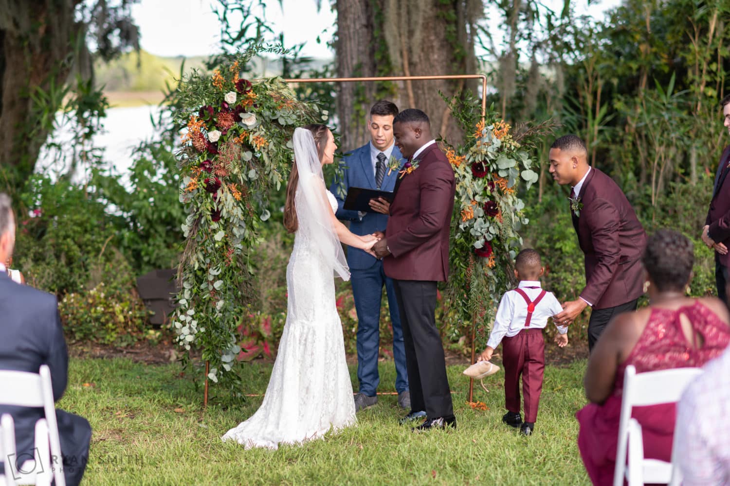 Bride and groom holding hands during ceremony - Magnolia Plantation - Charleston, SC