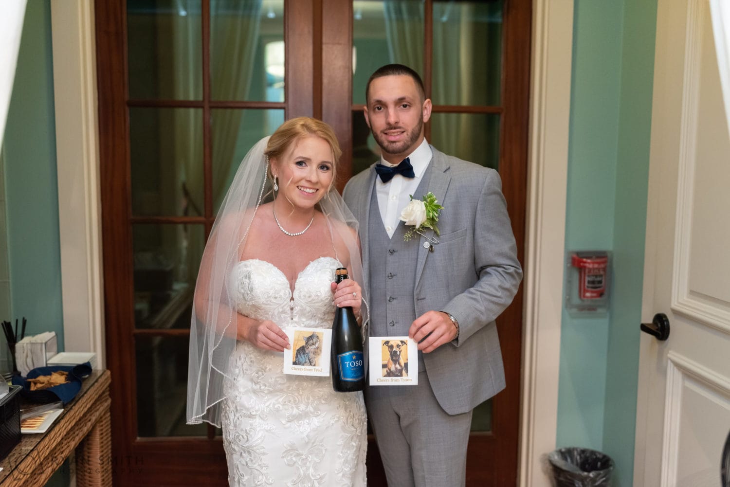 Bride and groom holding napkins with their pets pictures  - 21 Main Events - North Myrtle Beach