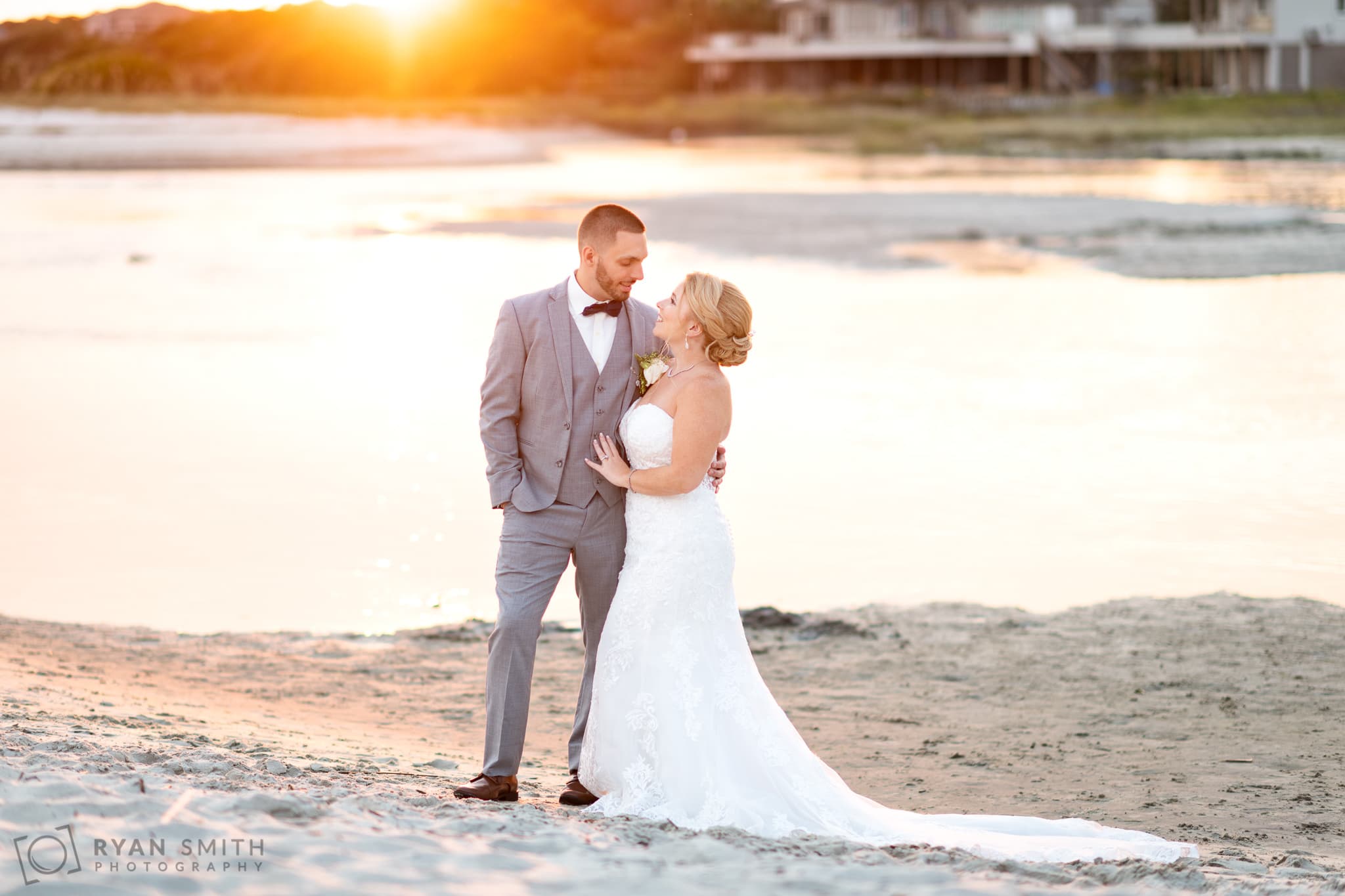 Bride and groom in front of the inlet backlit by sunset - 21 Main Events - North Myrtle Beach
