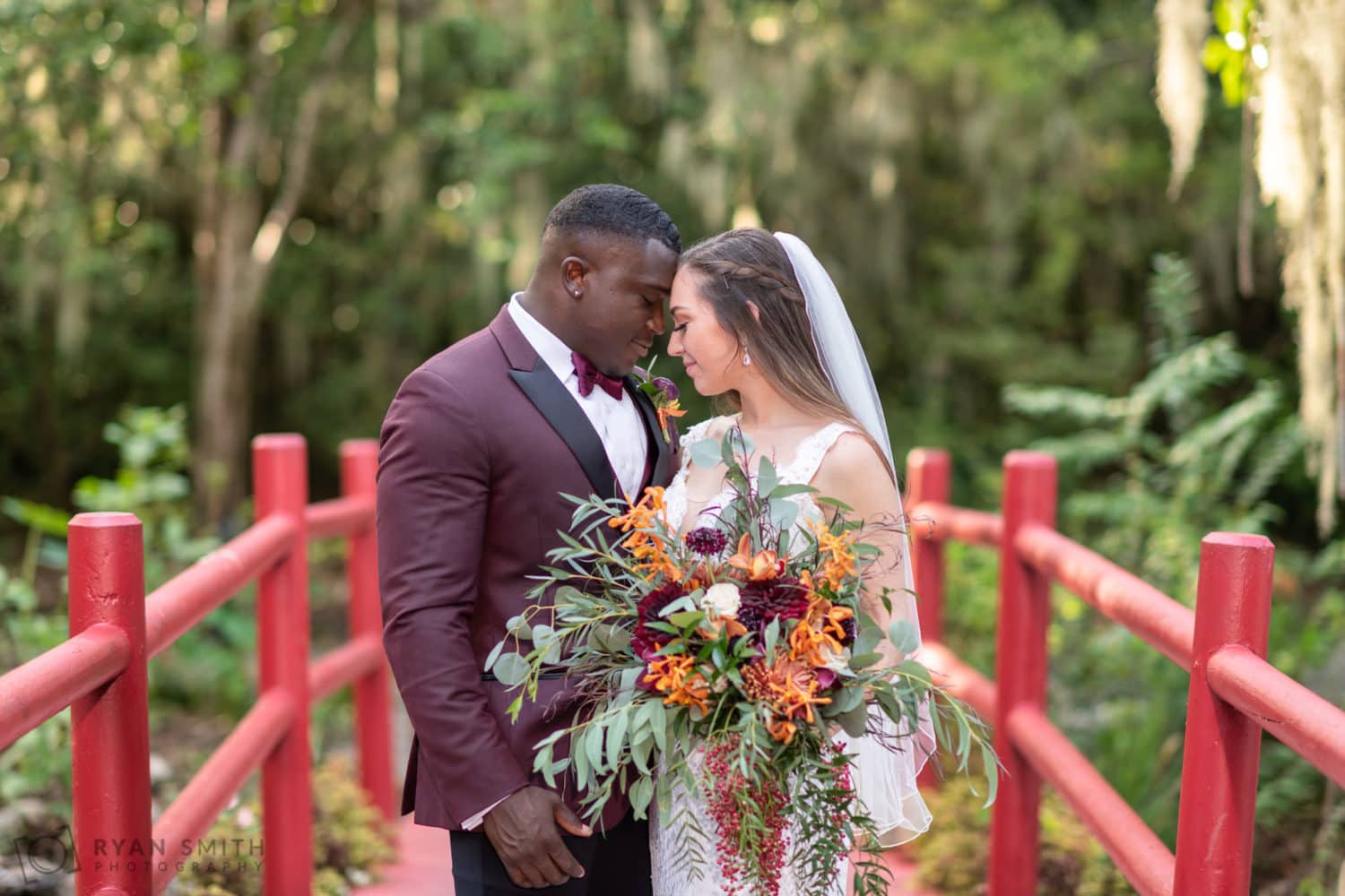 Bride and groom touching foreheads  - Magnolia Plantation - Charleston, SC