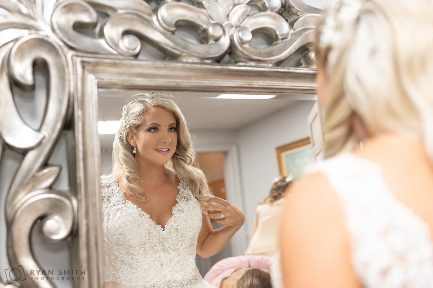 Bride looking at her makeup in the mirror - Litchfield Country Club