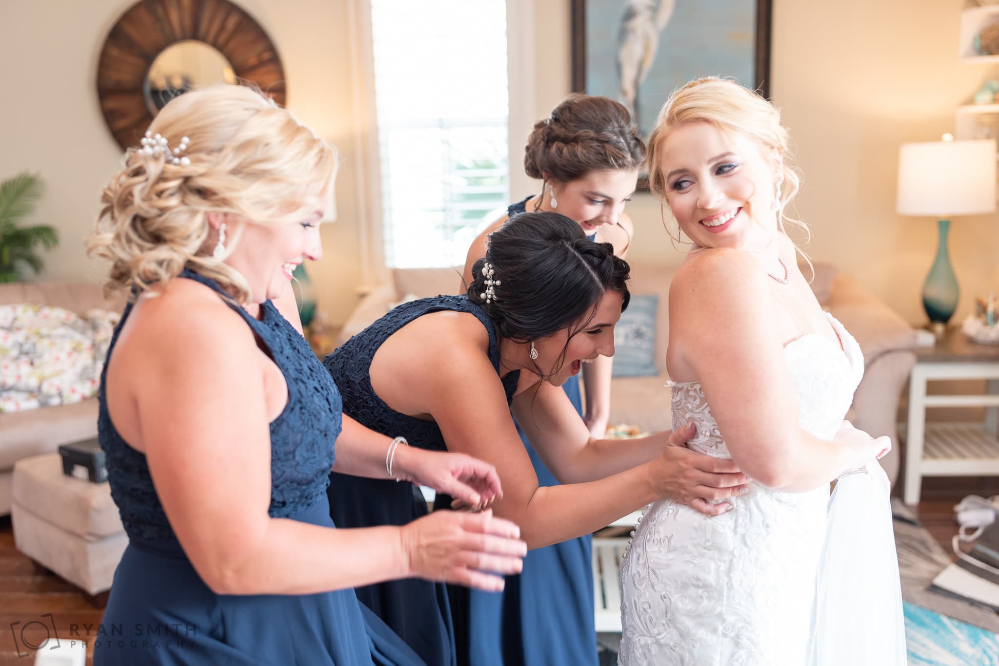 Bridesmaids helping bride with the dress - 21 Main Events - North Myrtle Beach