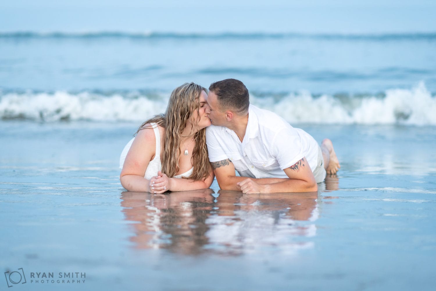Couple laying in the water together - Huntington Beach State Park