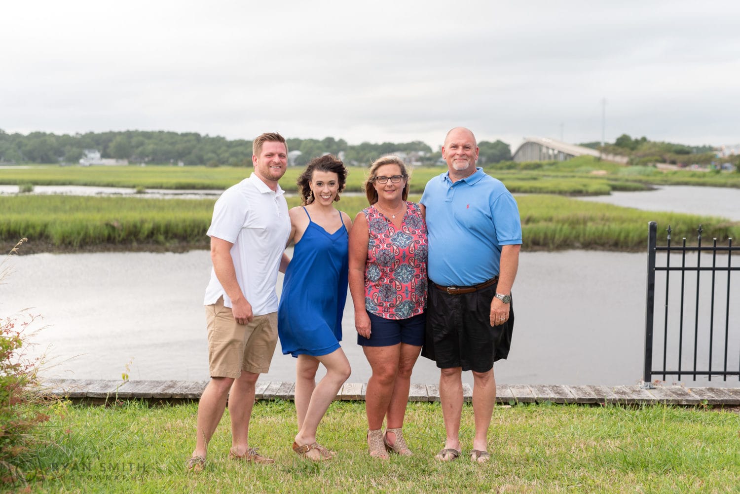 Family in front of the bridge and marsh - Ocean Isle