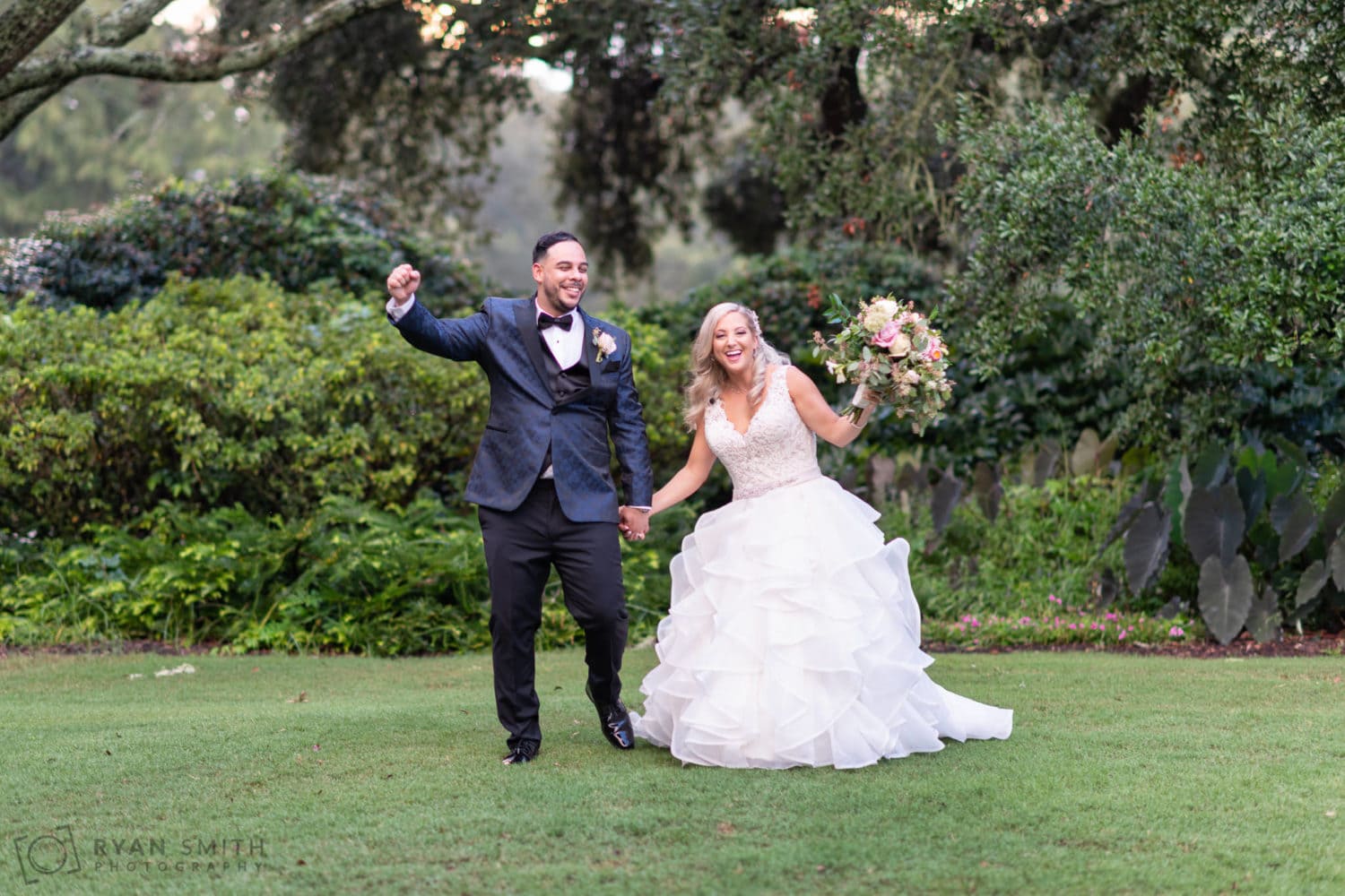 Happy bride and groom cheering on the lawn - Litchfield Country Club