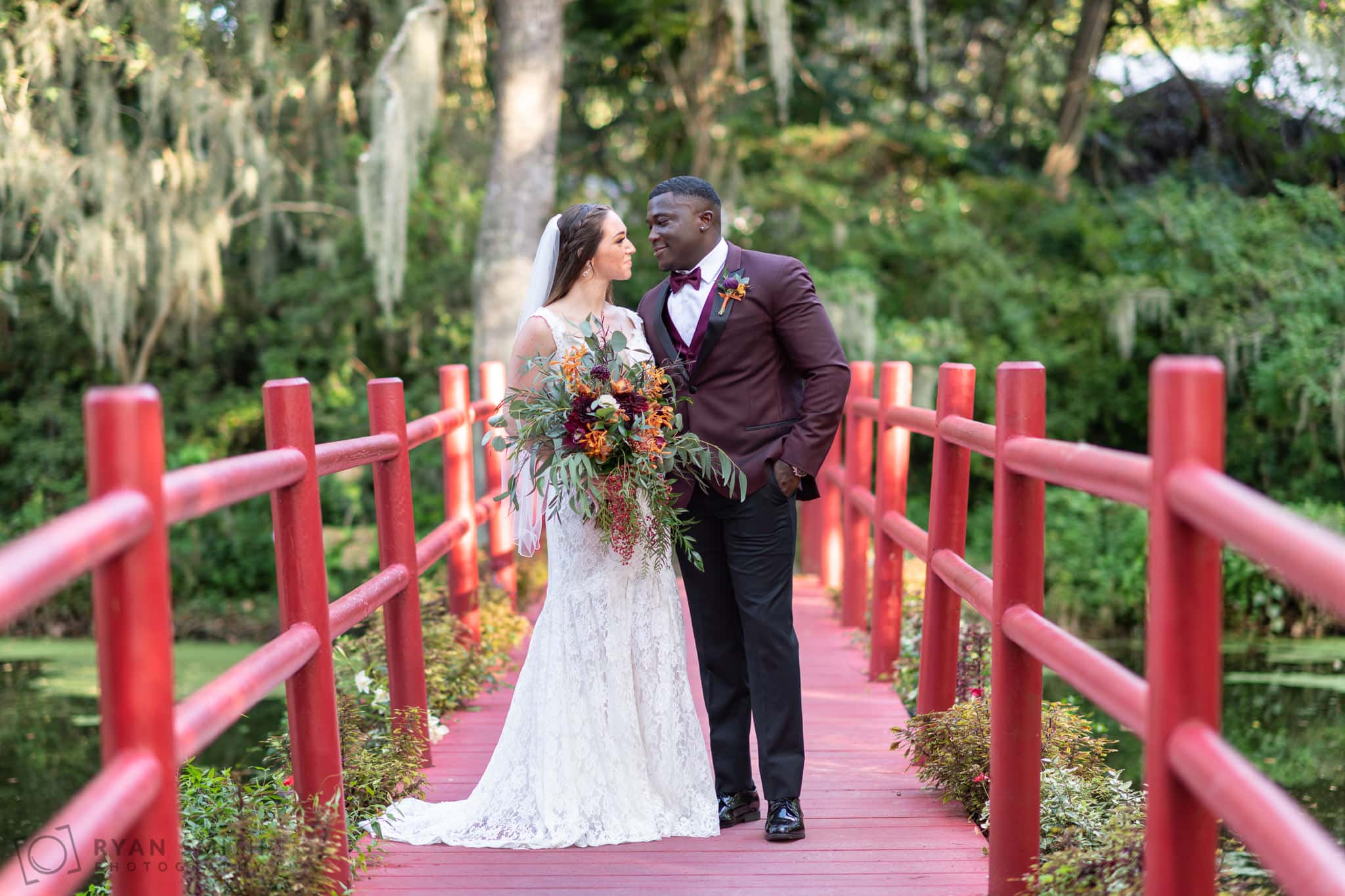 Portraits of bride and groom on the red bridge - Magnolia Plantation - Charleston, SC