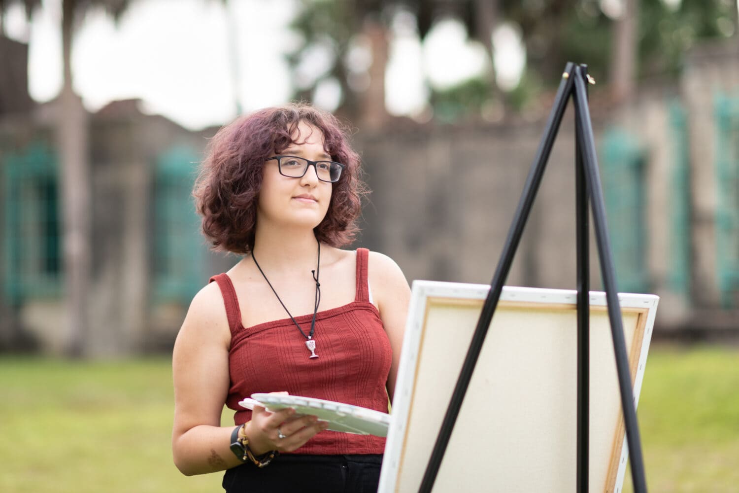 Senior portraits by the ocean and Atalaya Castle for an artist with her canvas and paints - Huntington Beach State Park