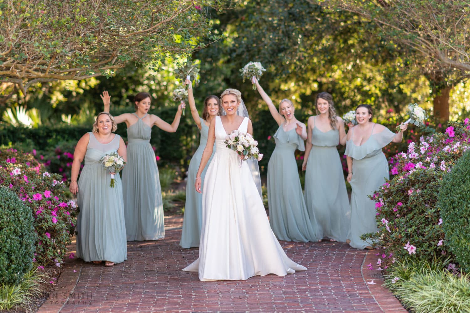 Bride and bridesmaids walking in the garden - Pine Lakes Country Club