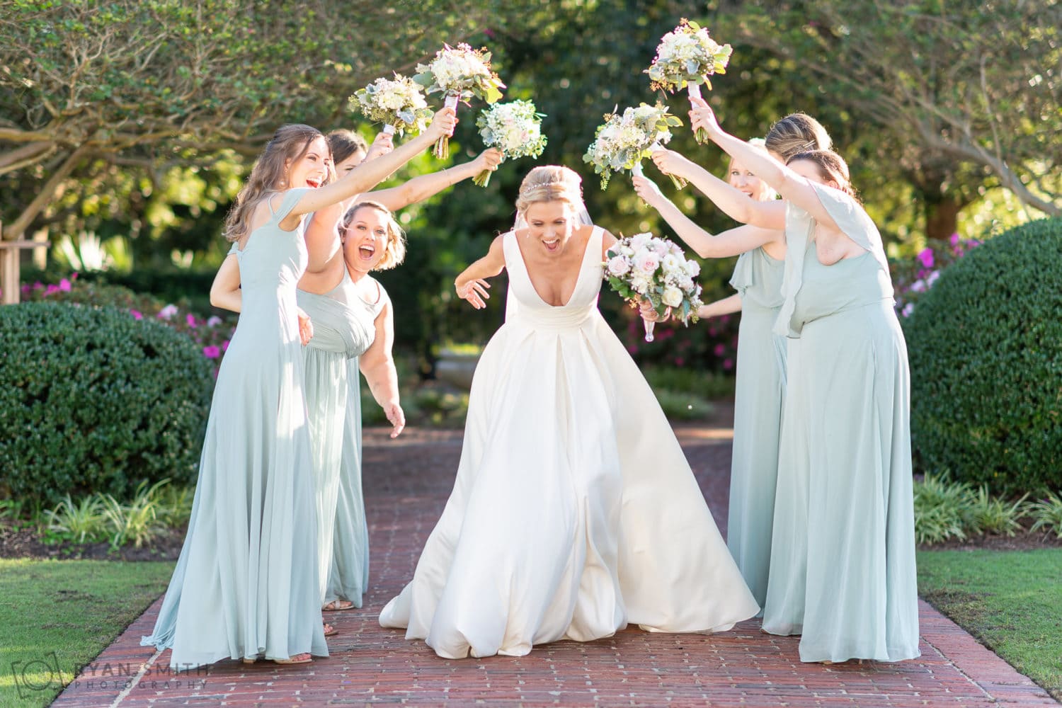 Bride running under the bouquets  - Pine Lakes Country Club