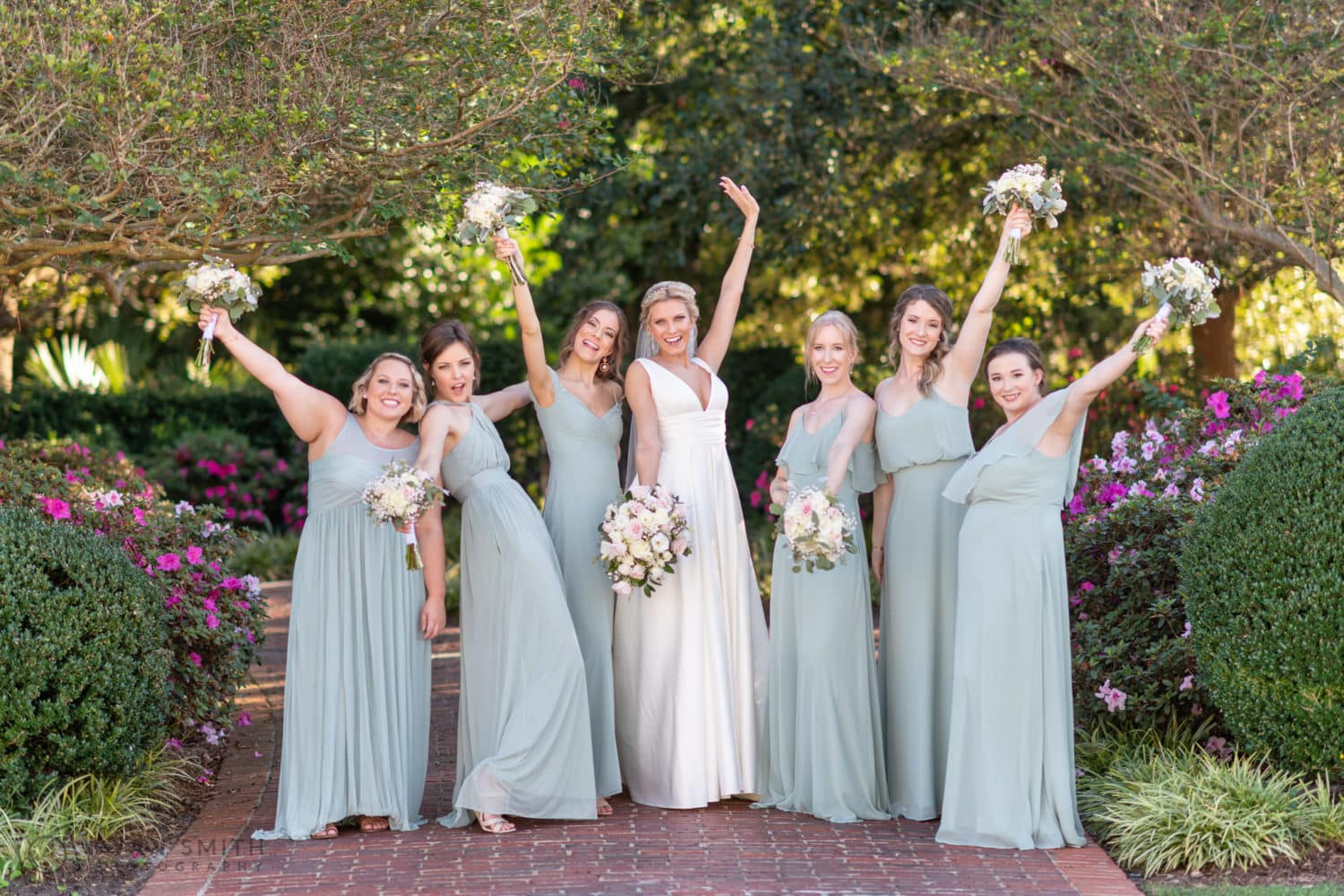 Bridesmaids holding the flowers in the air - Pine Lakes Country Club