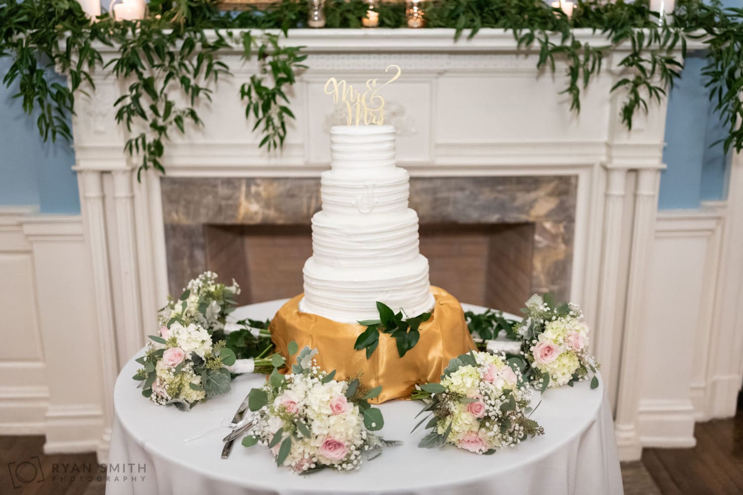 Cake surrounded by bouquets  - Pine Lakes Country Club