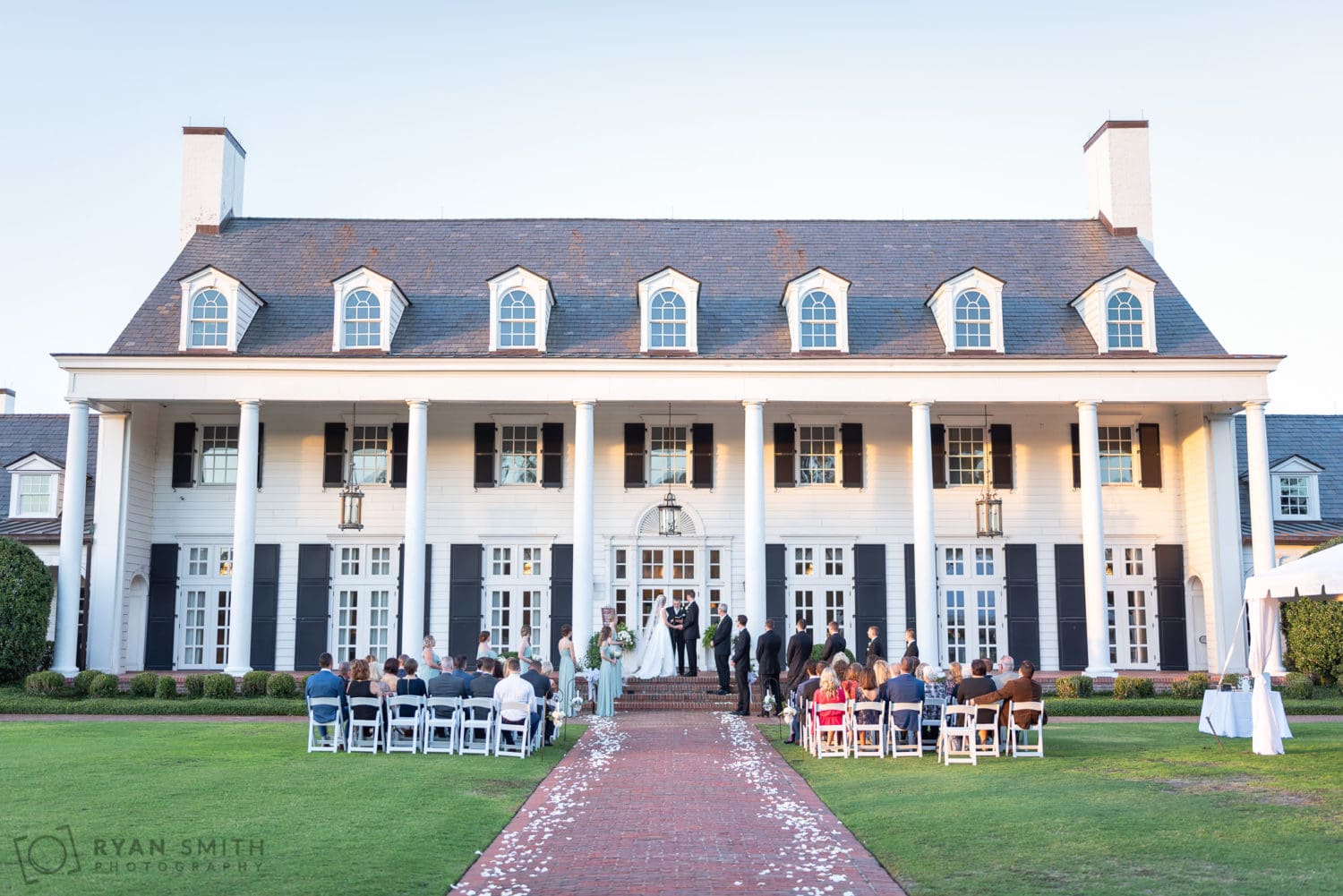 Sunset ceremony on the lawn facing the clubhouse - Pine Lakes Country Club