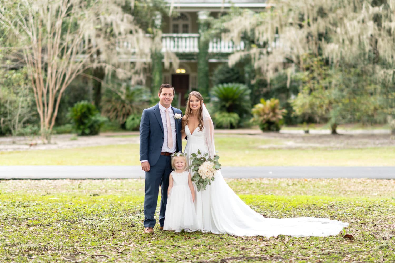 Bride and groom with their daughter - Oak Allee - Wachesaw Plantation