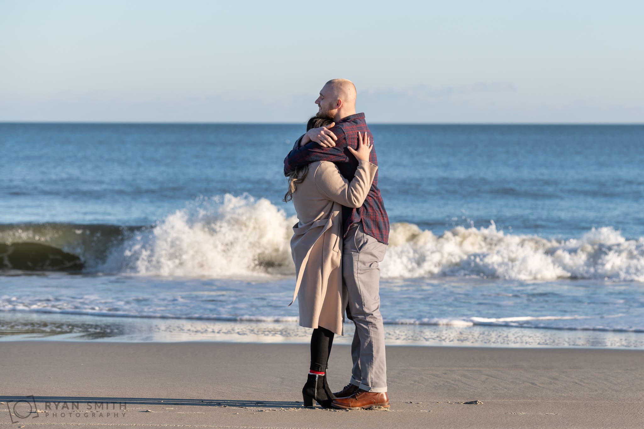 Couple embracing after marriage proposal - Huntington Beach State Park
