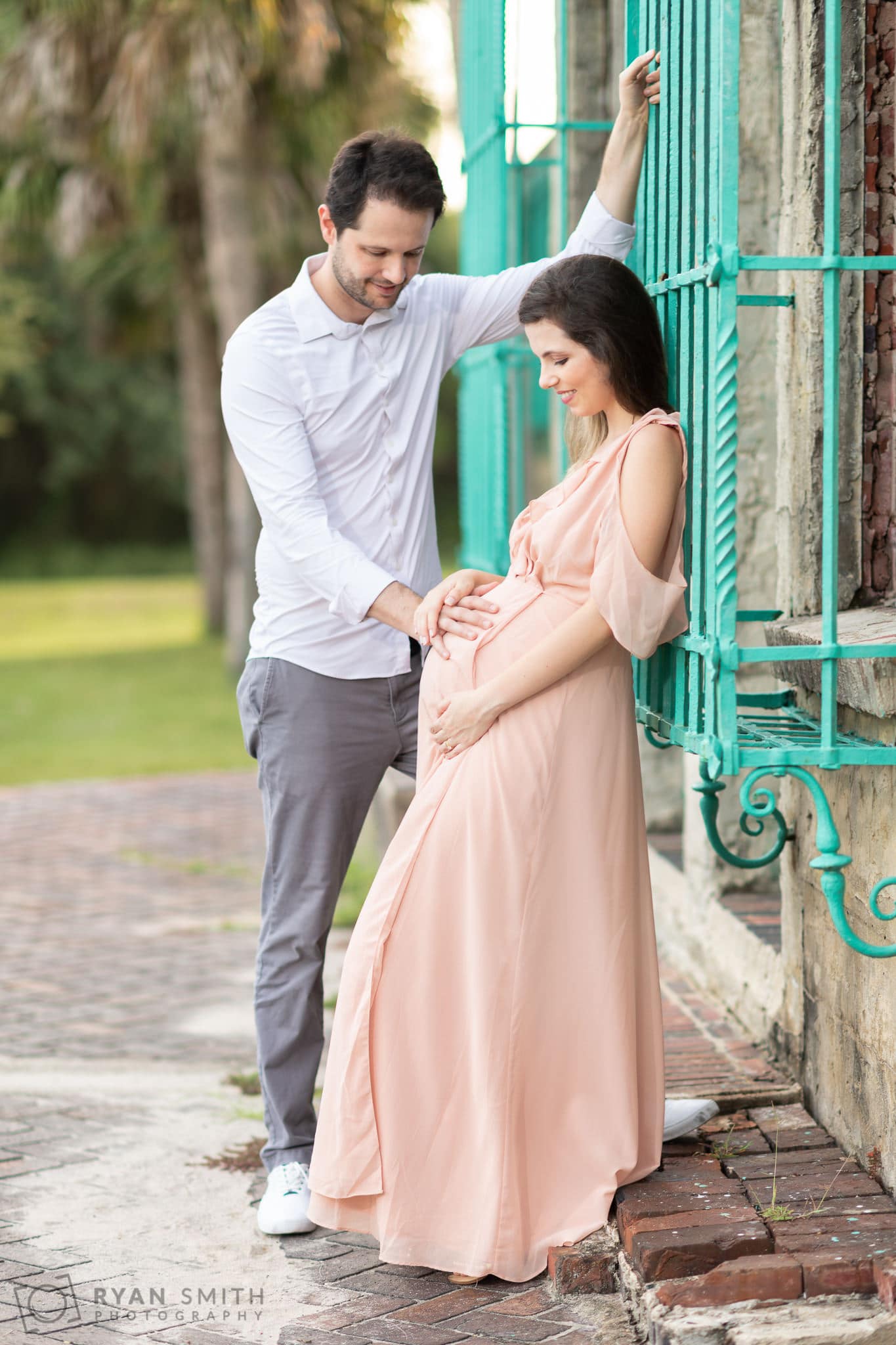 Couple looking at expectant mother's belly - Atalaya Castle