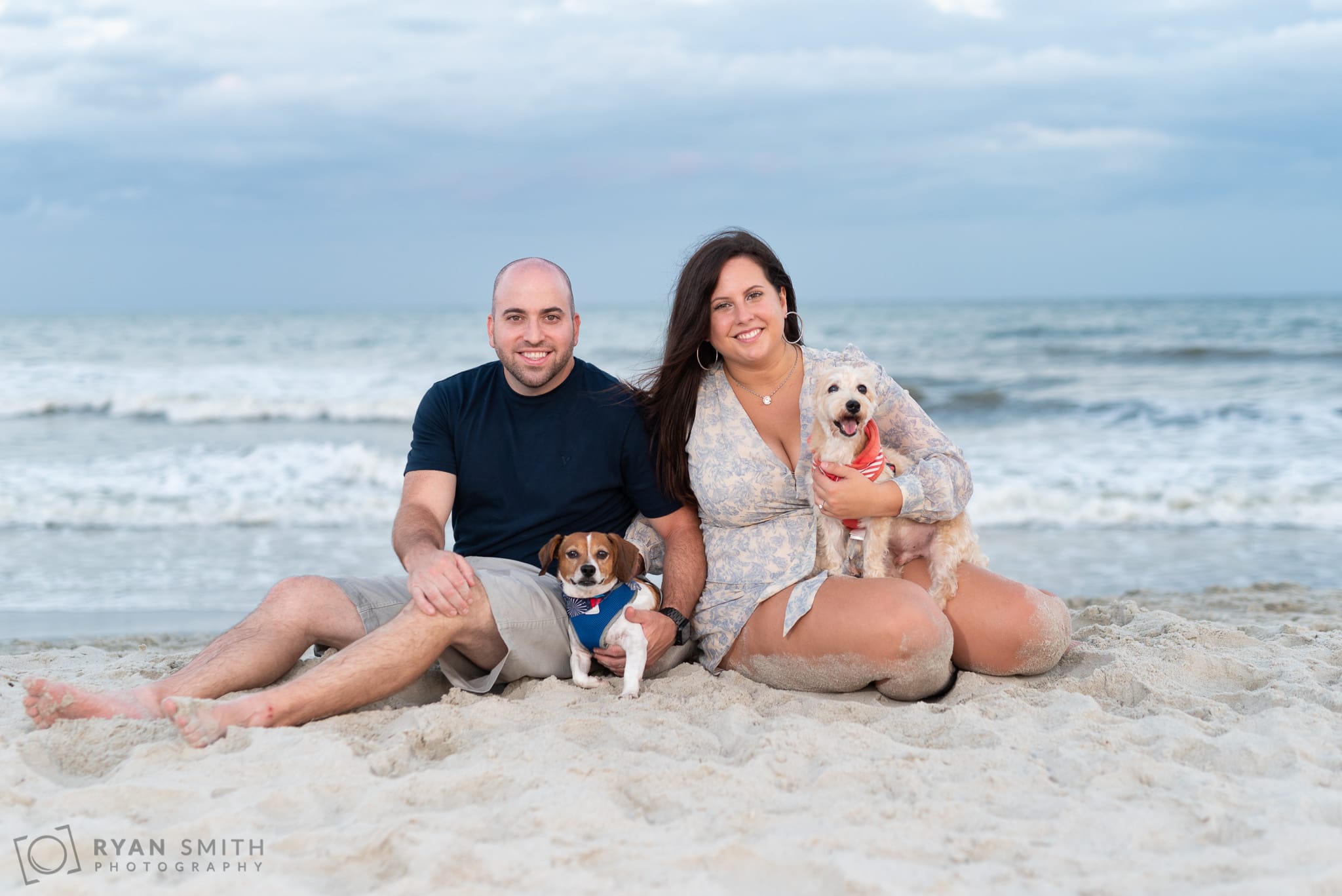 Engagement pictures with the dogs in front of the ocean - Huntington Beach State Park