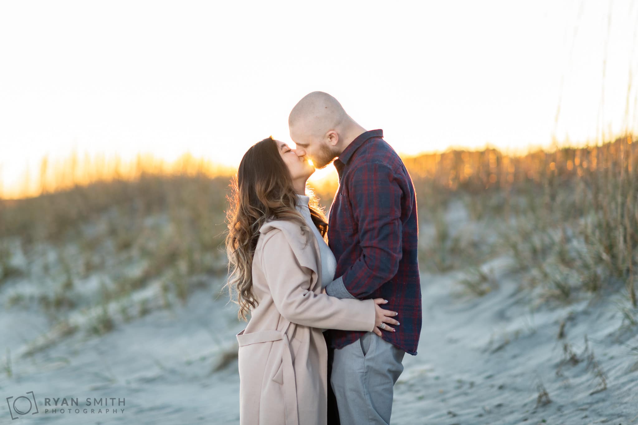Kiss with the sunset right behind the couple - Huntington Beach State Park