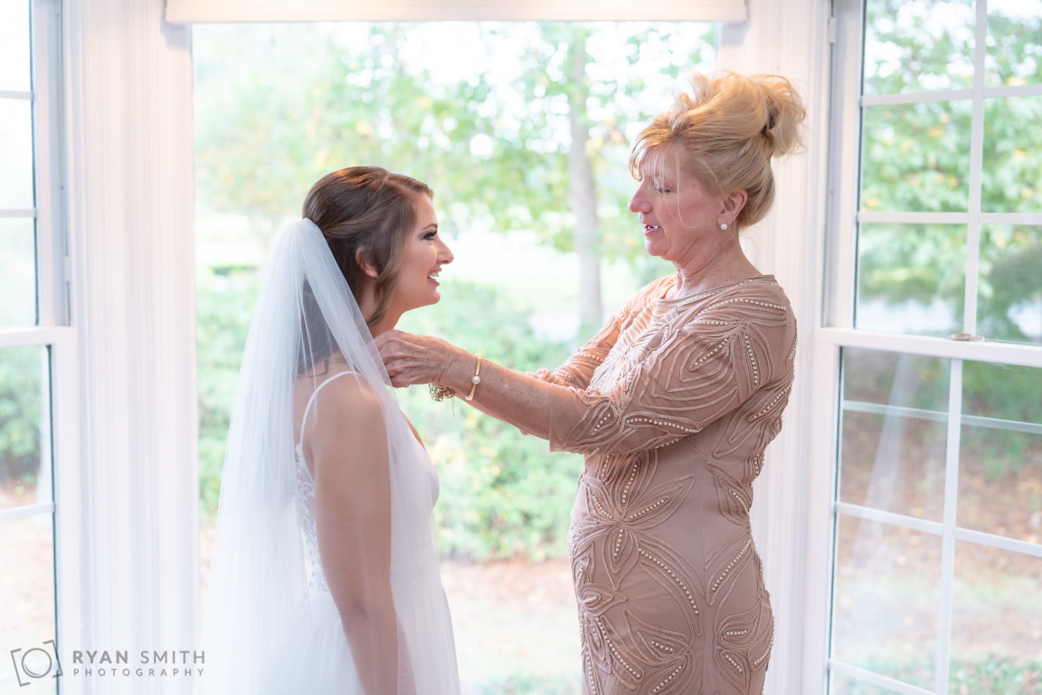 Mother helping bride with her dress - Wachesaw Plantation
