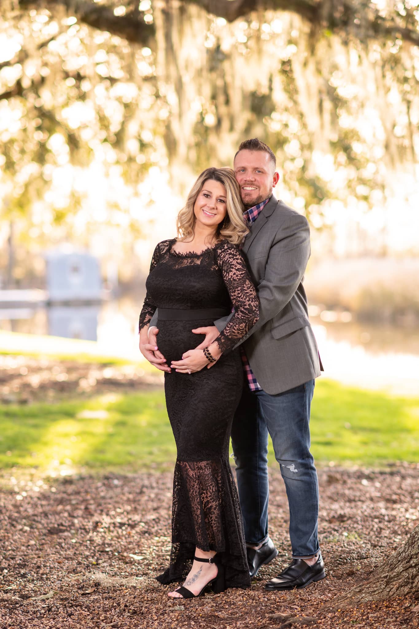 Maternity portrait with husband with arms around wife's belly  - Caledonia Golf & Fish Club