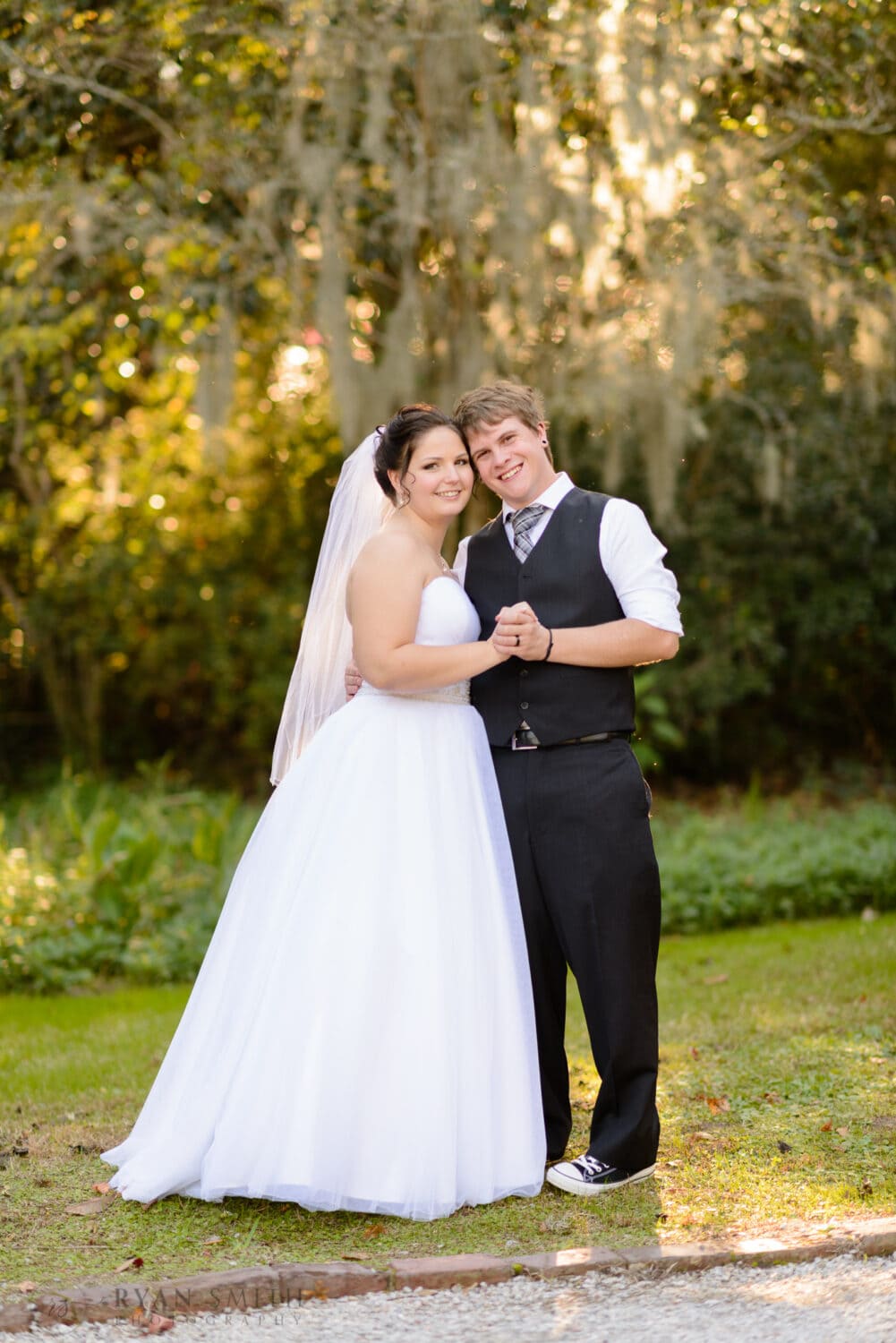 Bride and groom after the ceremony under the moss - Magnolia Plantation