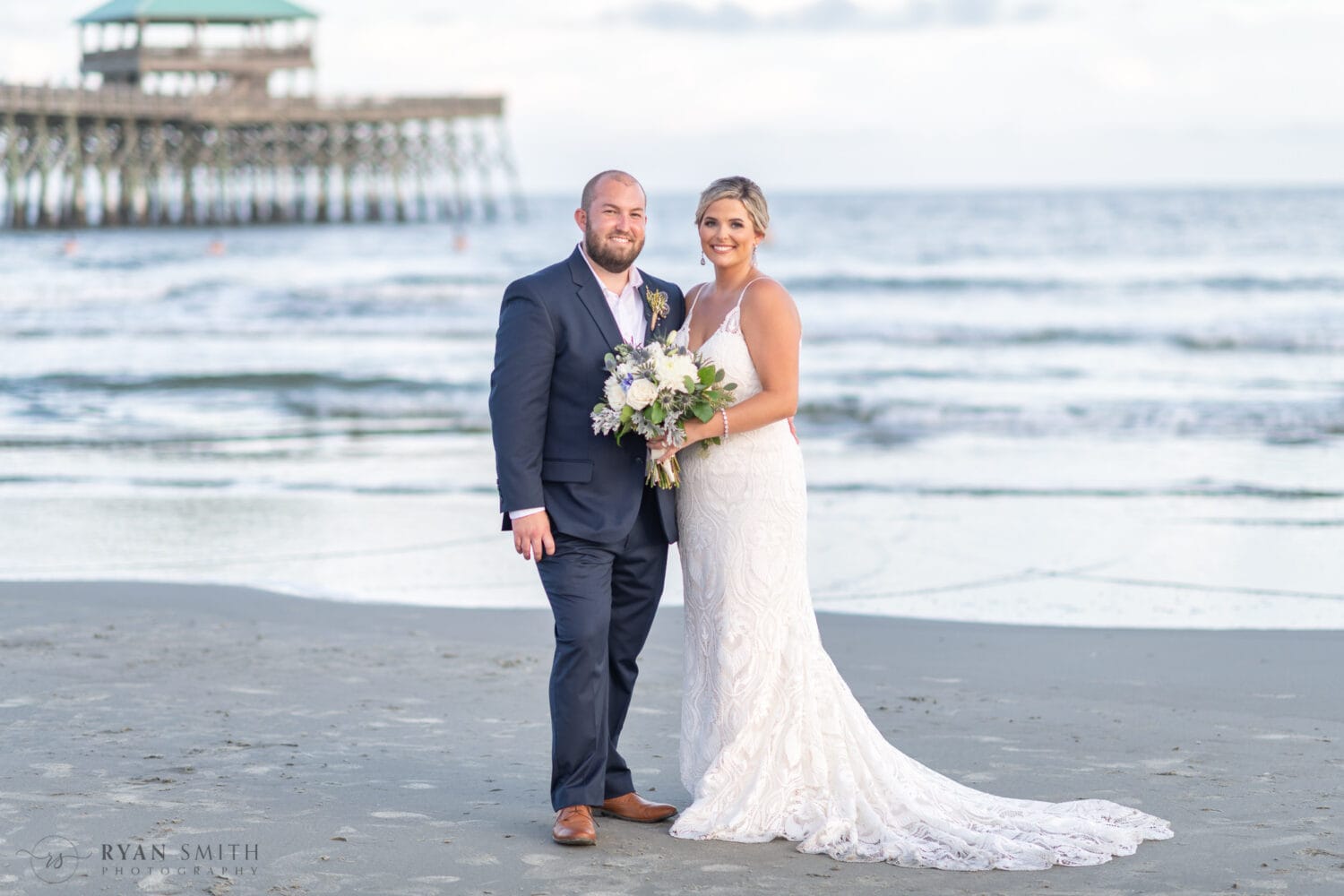 Bride and groom in front of the pier - Folly Beach - Charleston