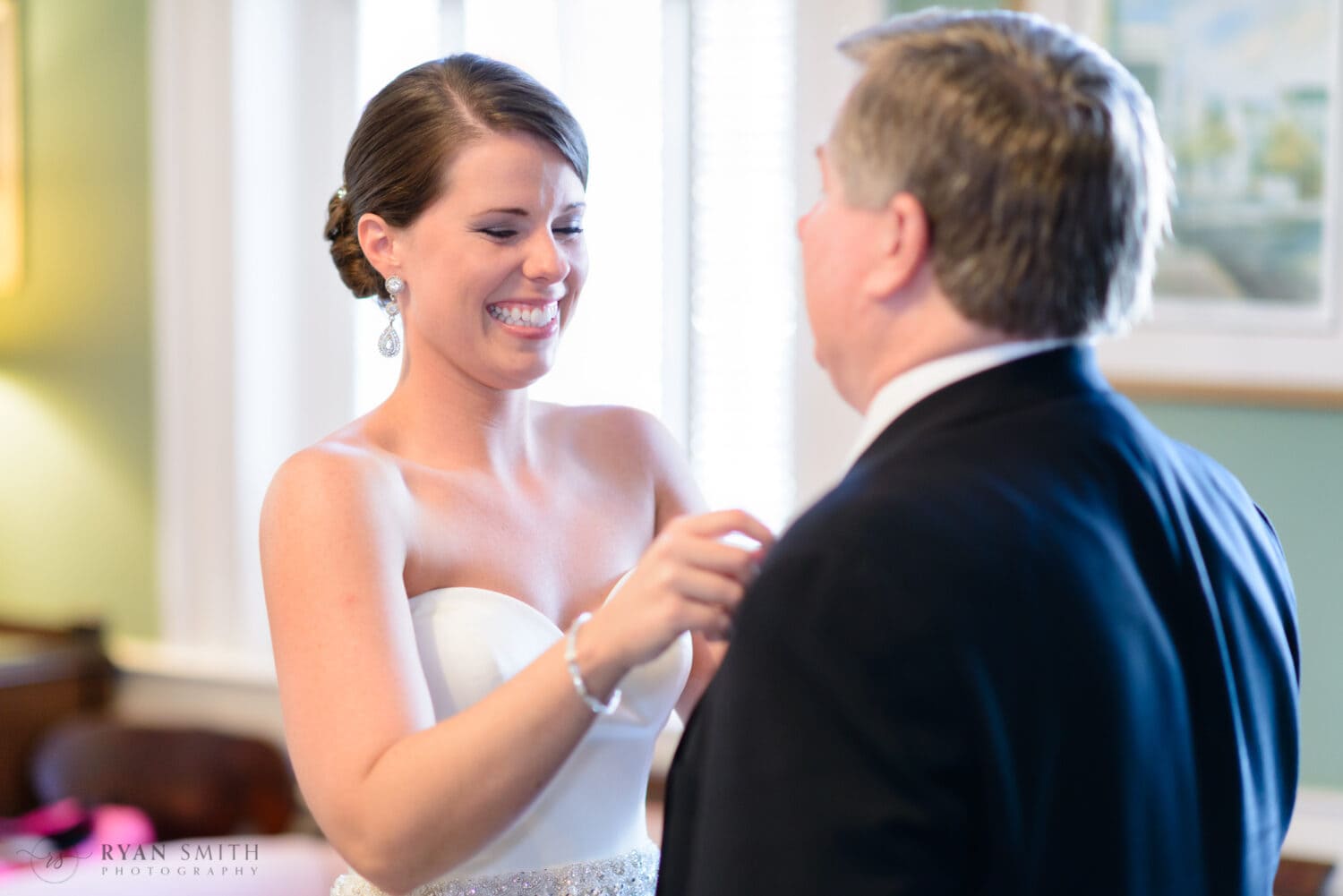 Bride helping dad with his boutonniere  - Downtown Charleston, SC