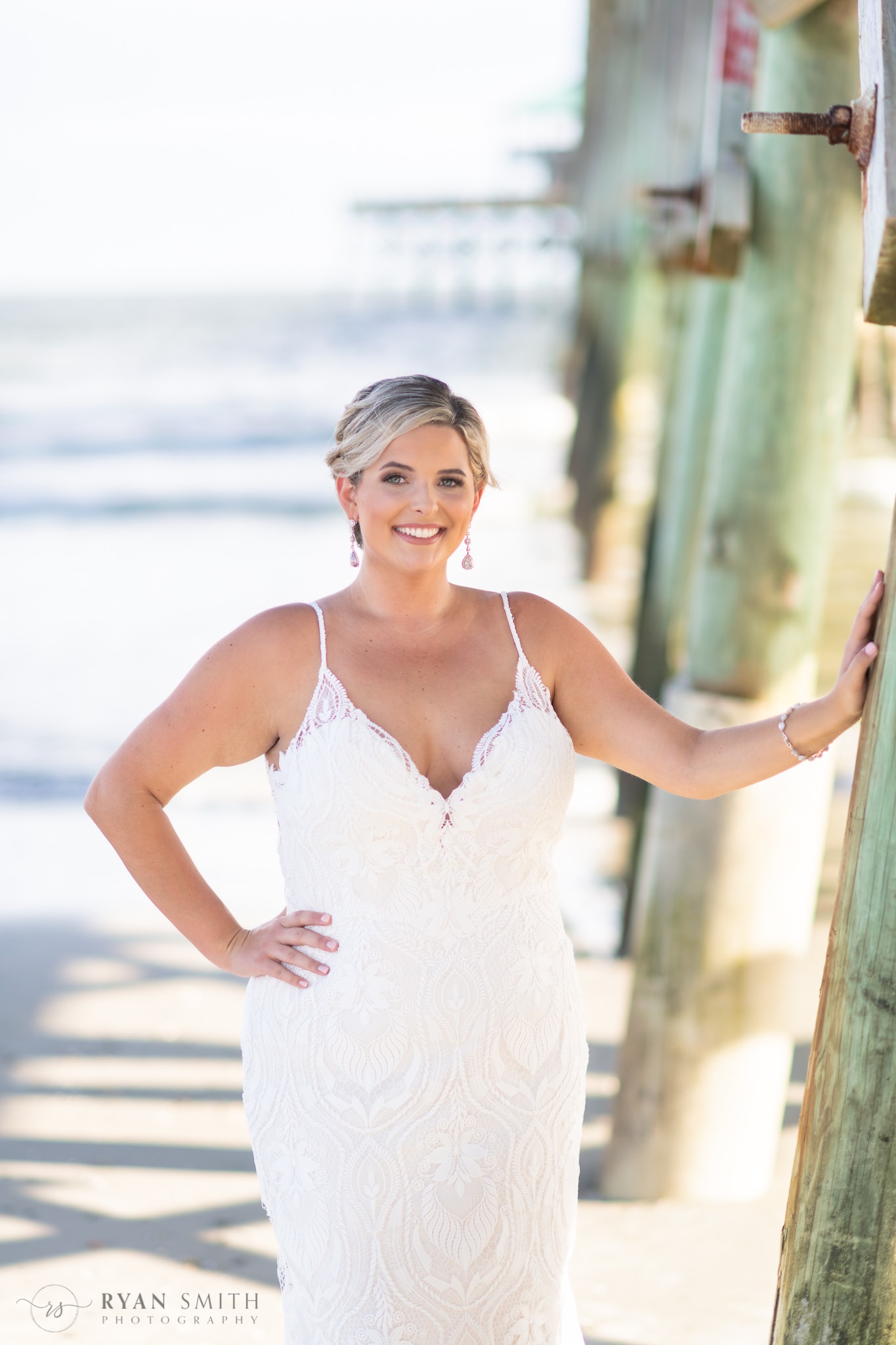 Bride posing by the pier  - Folly Beach - Charleston