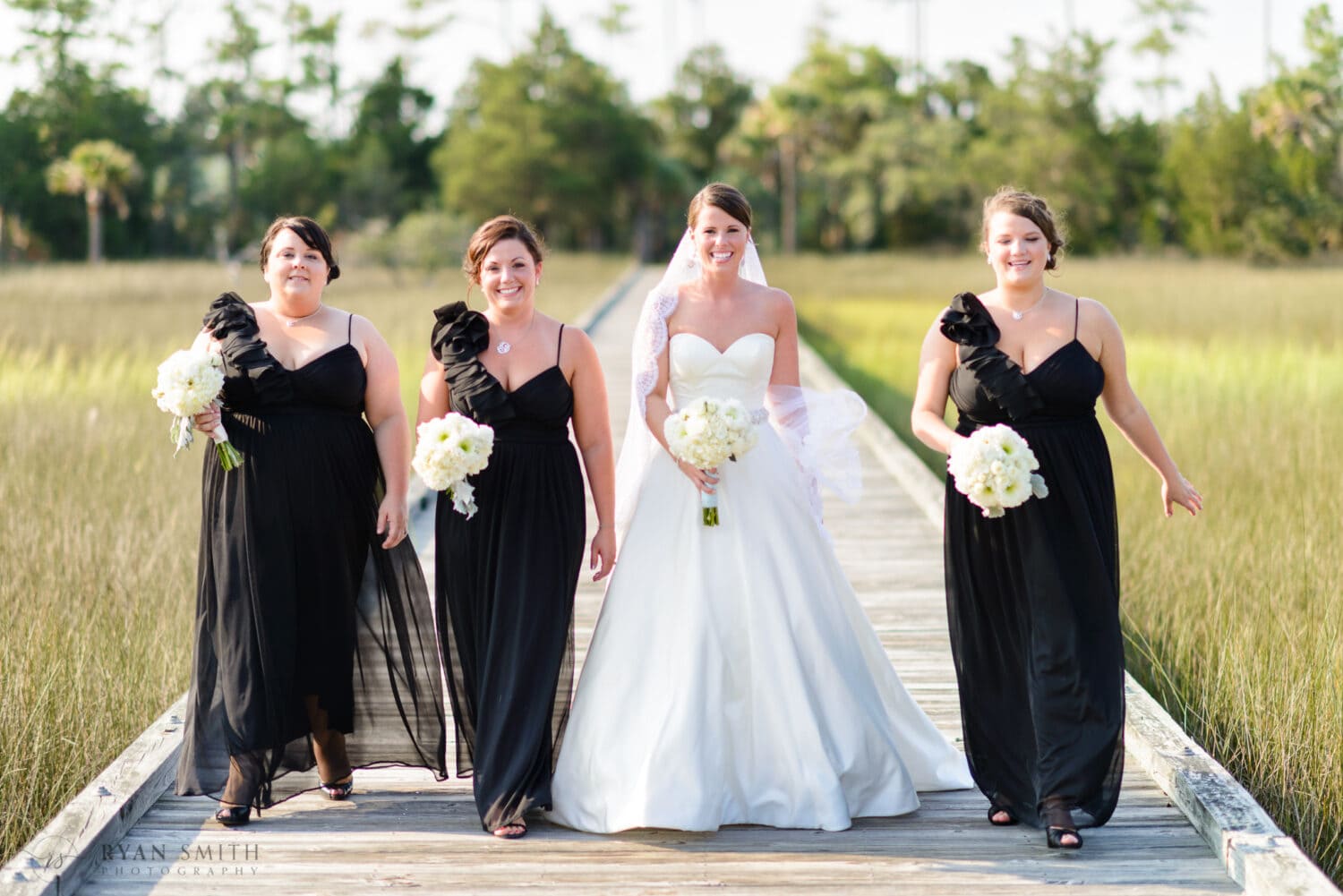Bridesmaids walking down the marsh boardwalk - Daniel Island Club - Charleston, SC