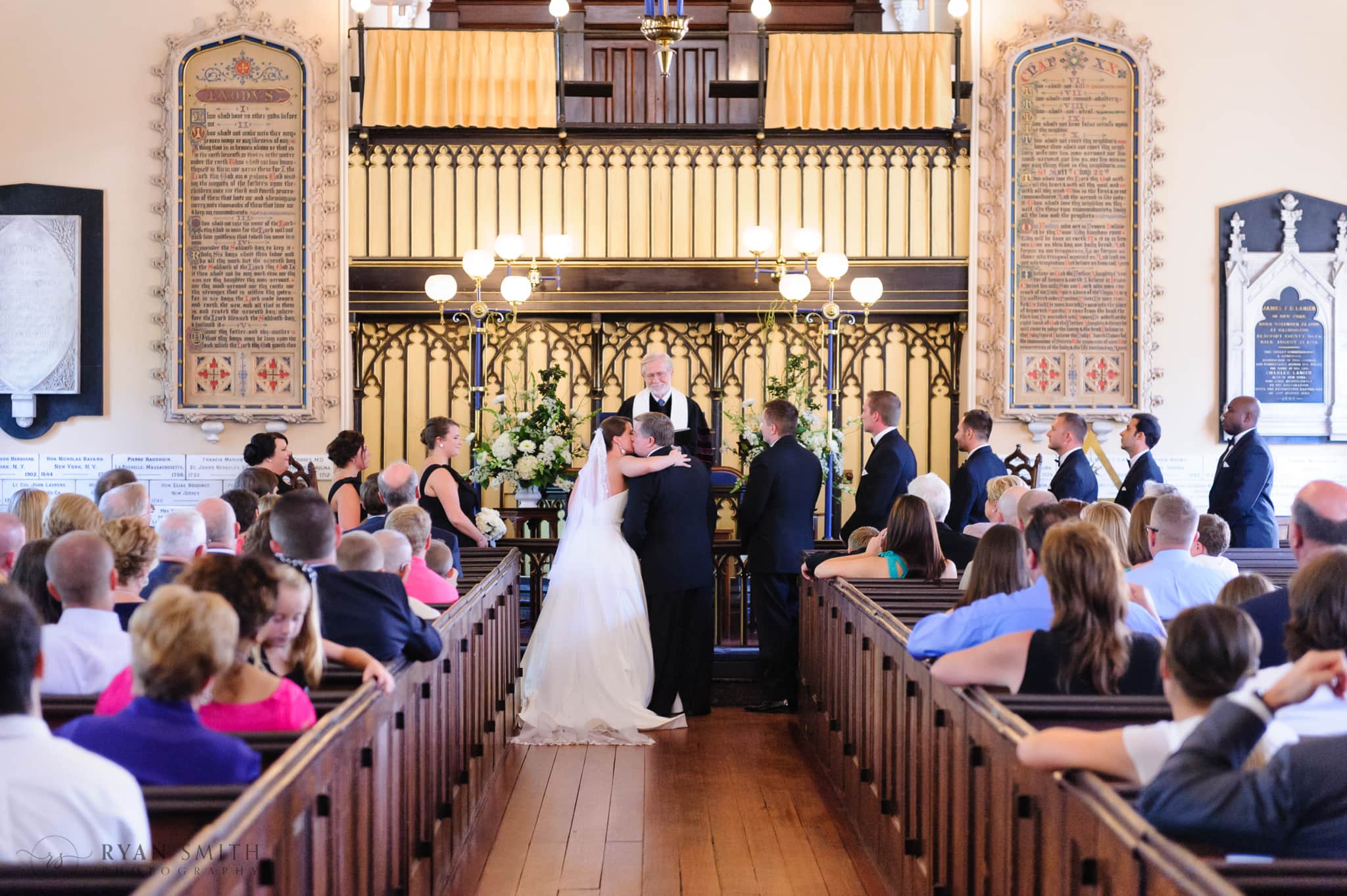Father giving away the bride with a kiss - French Huguenot Protestant Church