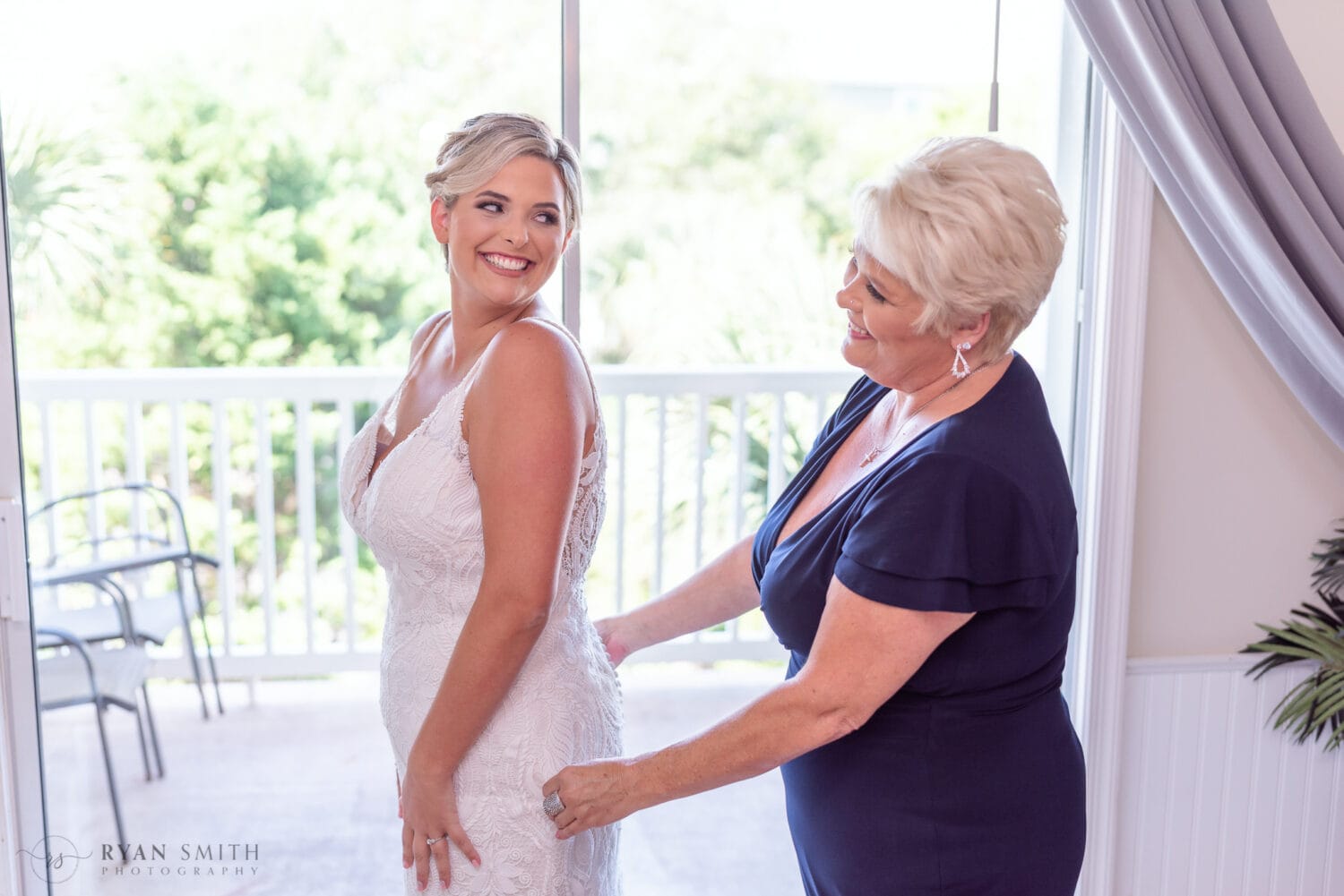 Mom helping bride with her dress - Folly Beach - Charleston