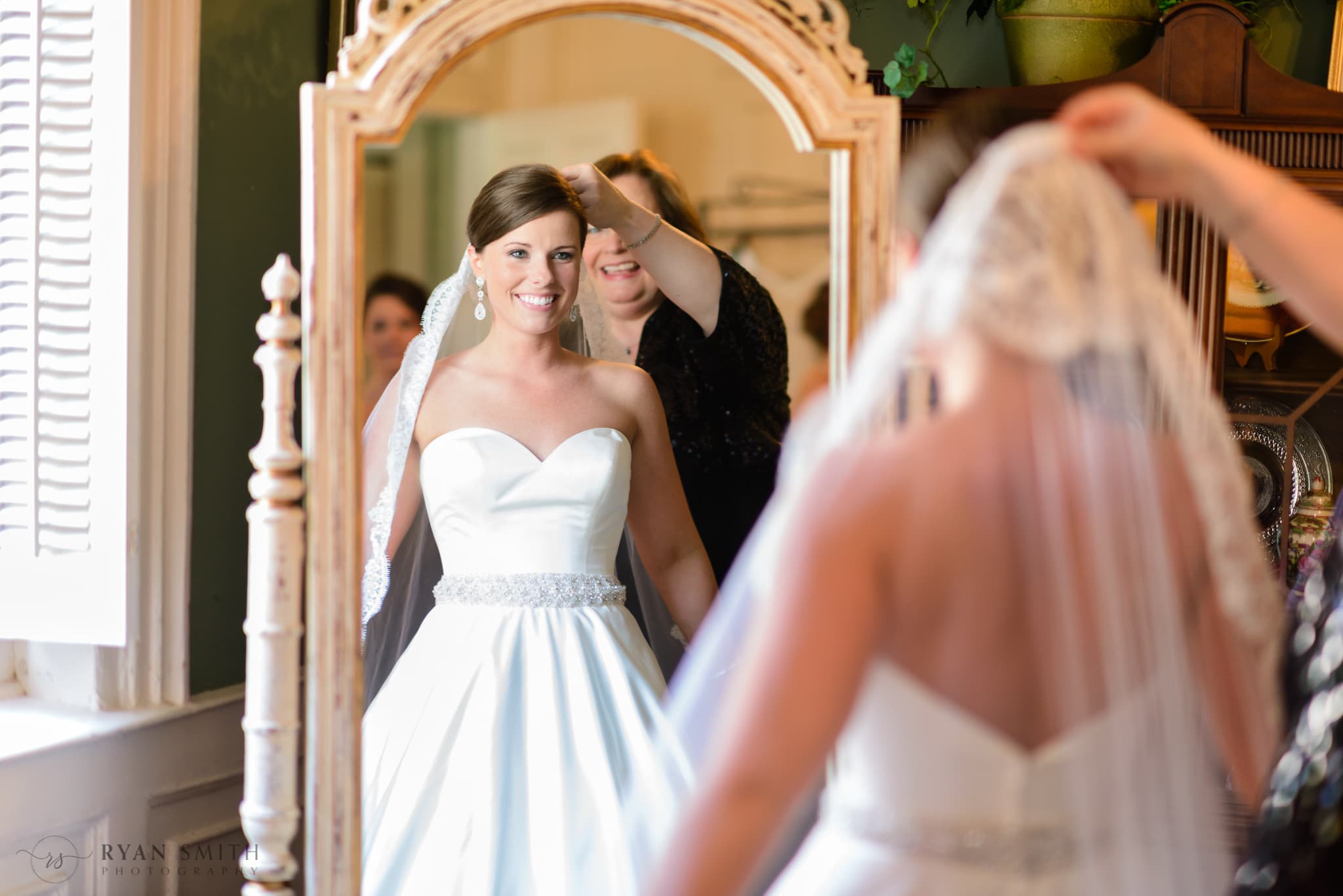 Mom helping bride with her veil in the mirror - Downtown Charleston, SC