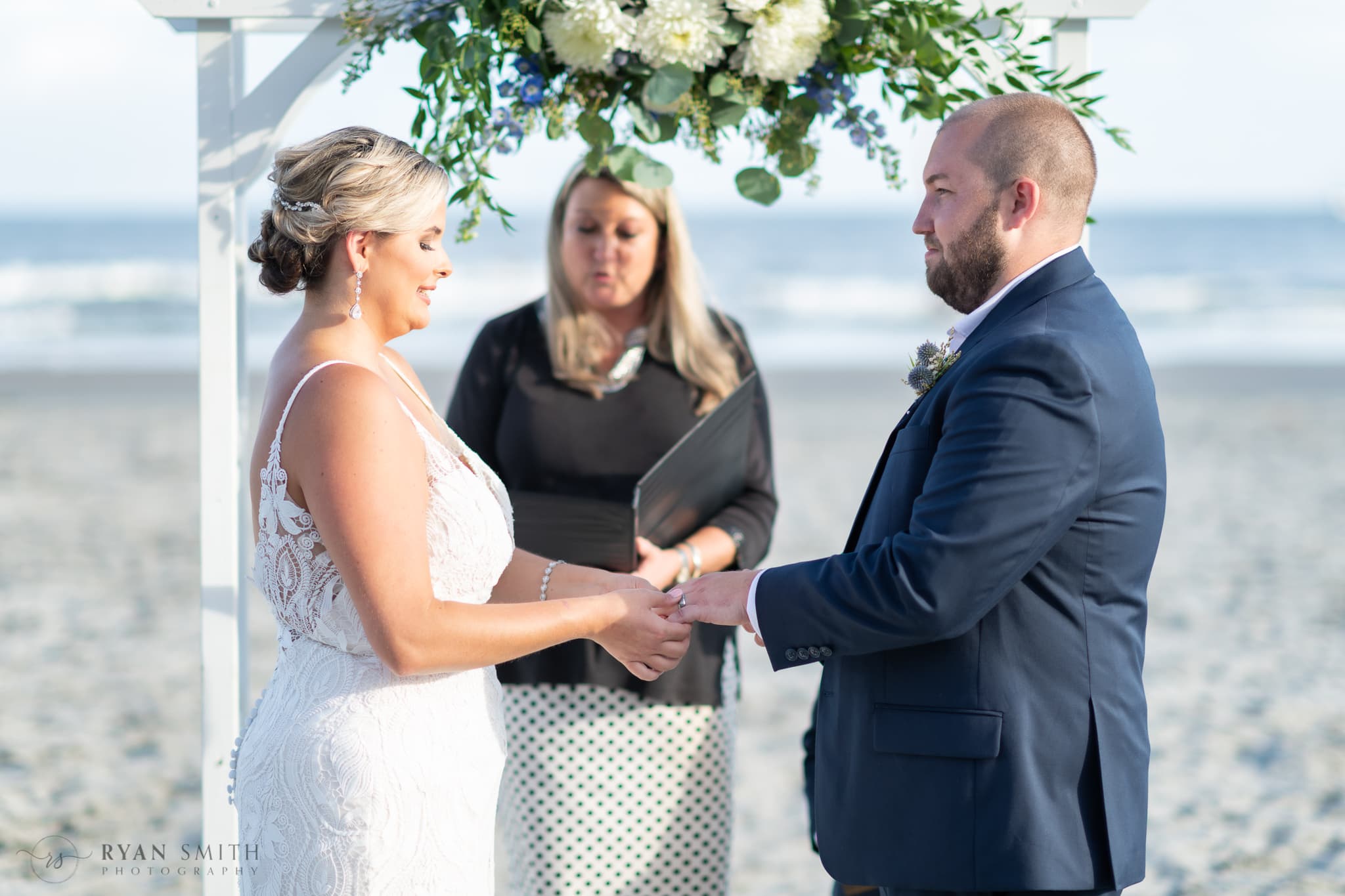 Putting on the groom's ring - Folly Beach - Charleston