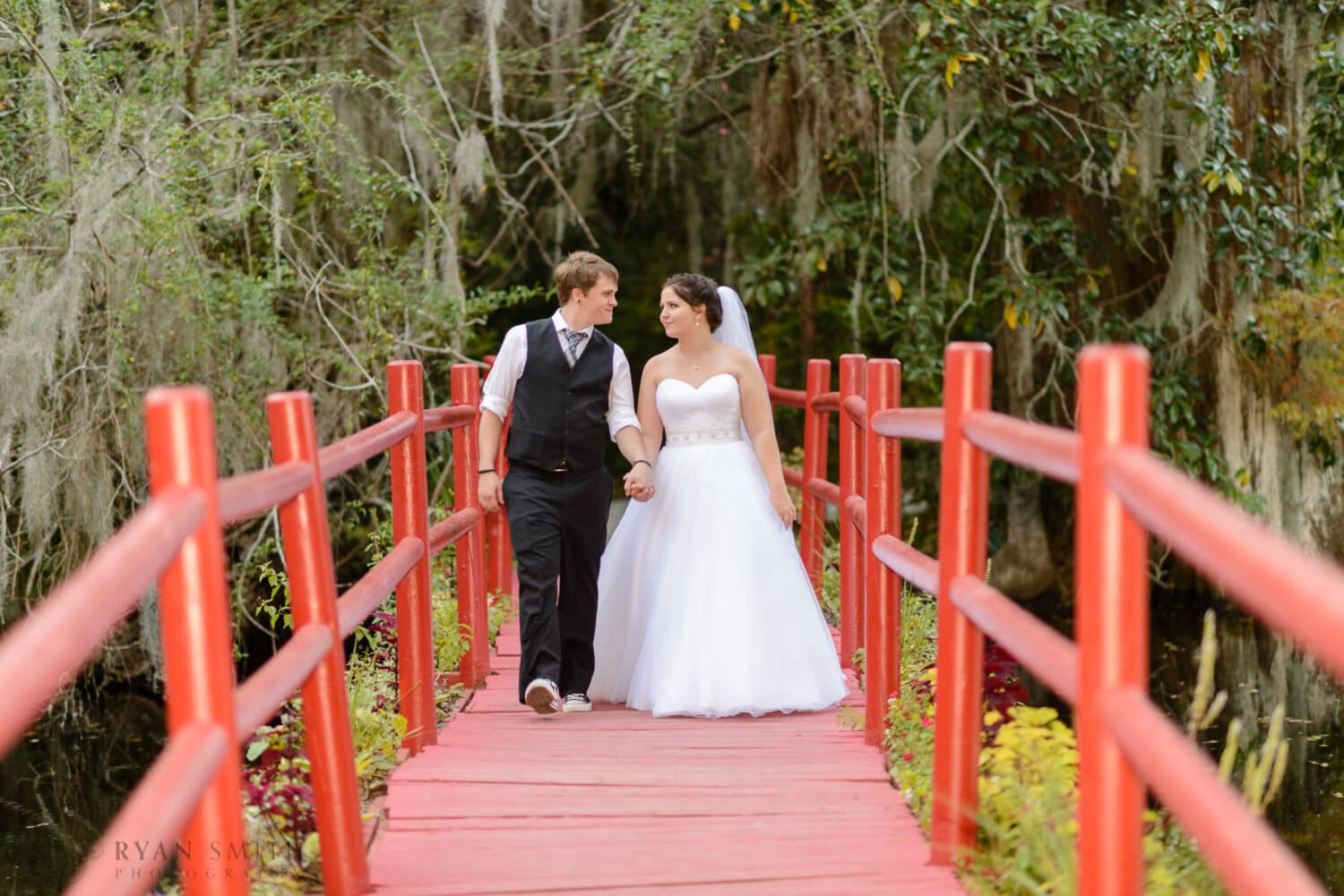Walking down the red bridge near the conservatory  - Magnolia Plantation
