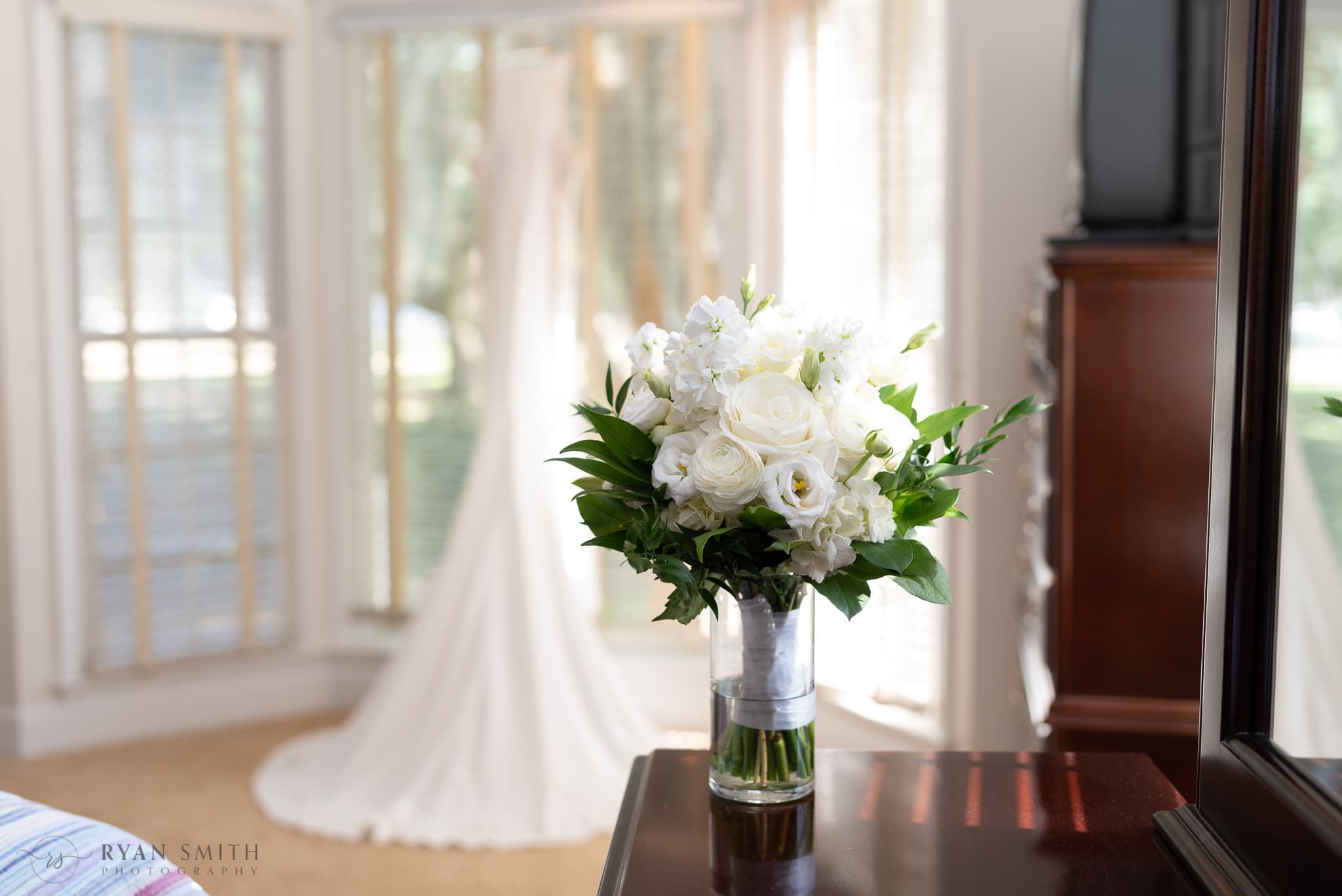 Bouquet with bride's dress in background - Kimbels at Wachesaw Plantation