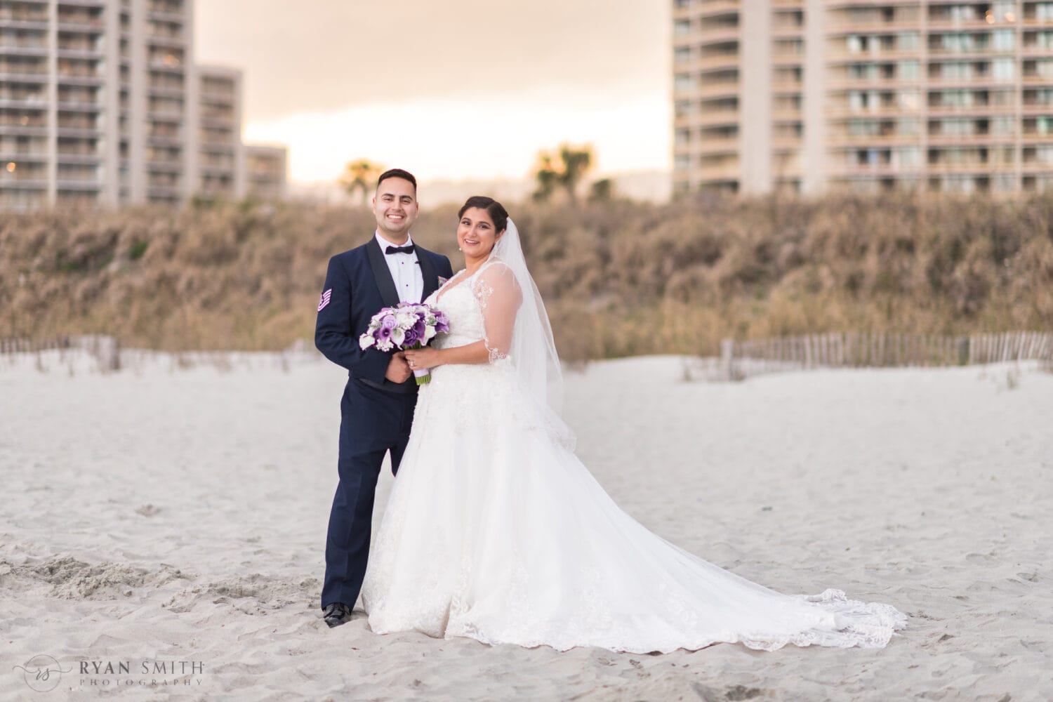 Bride and groom in front of the towers behind the dunes - 21 Main Events at North Beach