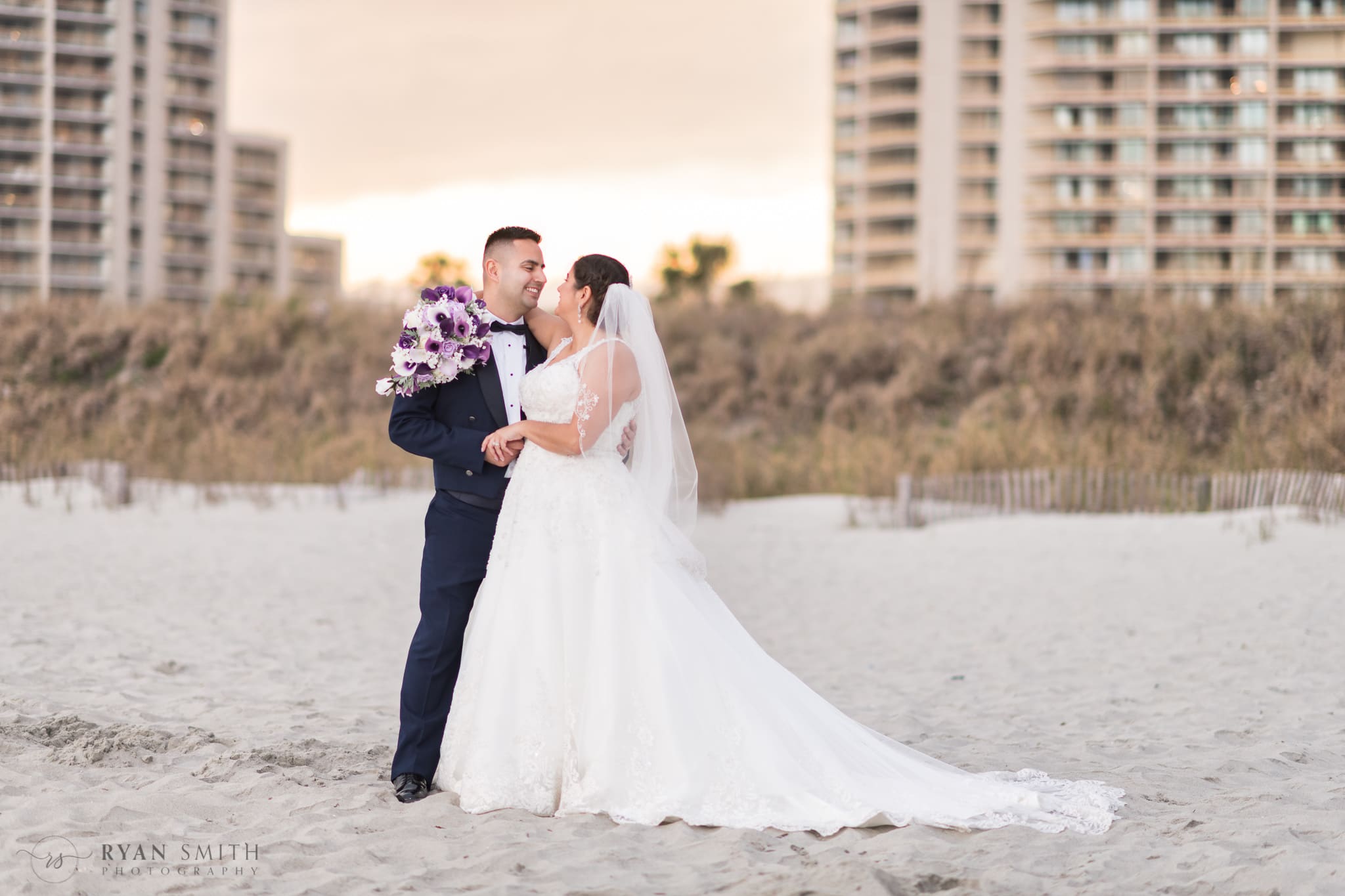 Bride and groom in front of the towers behind the dunes - 21 Main Events at North Beach