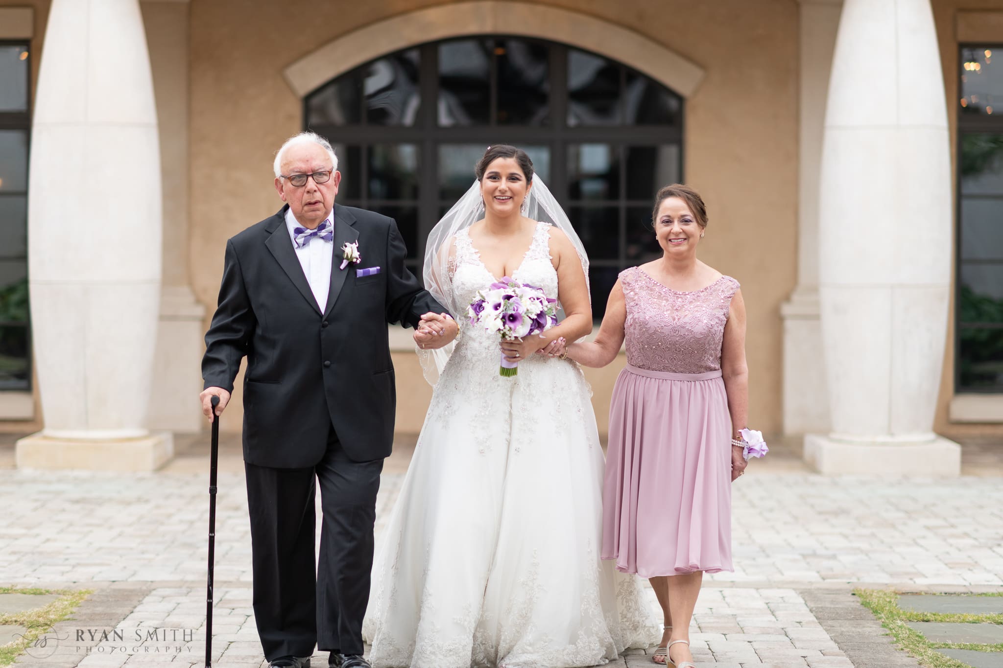 Bride walking down aisle with parents - 21 Main Events at North Beach