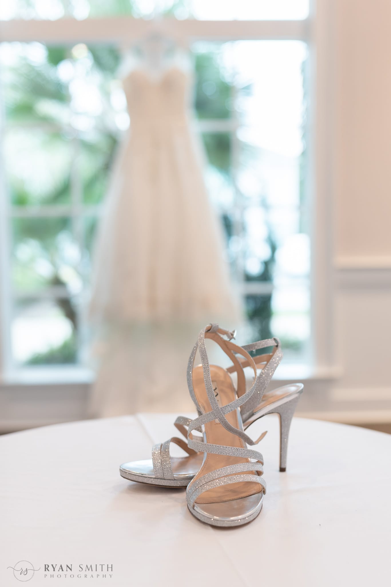 Bride's shoes in focus with dress hanging in the background - 21 Main Events at North Beach