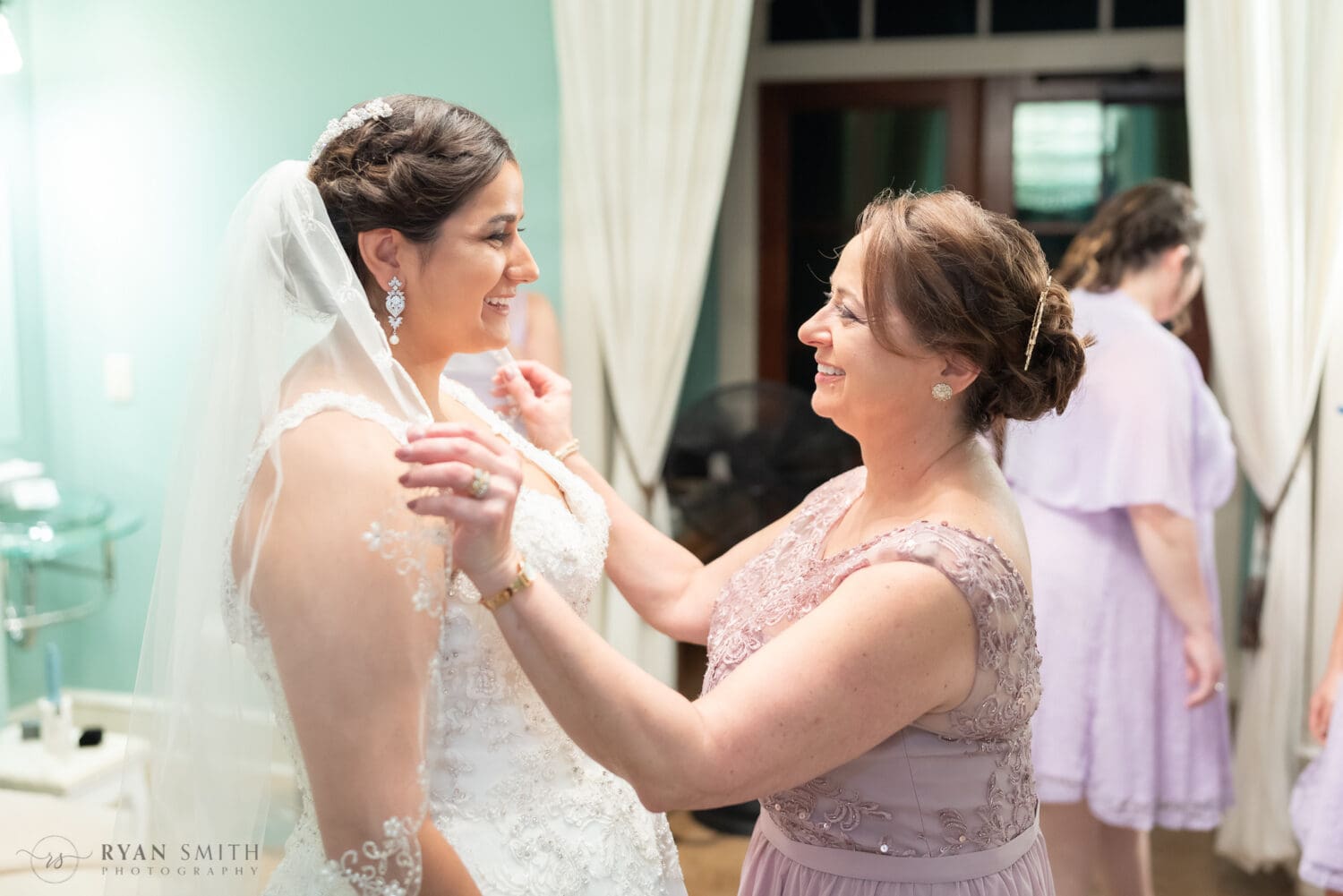Mom pulling bride's veil over her shoulders  - 21 Main Events at North Beach