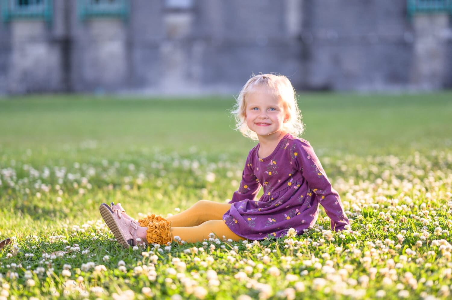 Cute baby girl sitting in the grass and flowers - Huntington Beach State Park