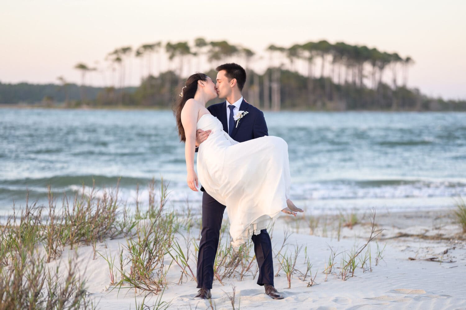 Groom holding the bride for a kiss - Cherry Grove Point - North Myrtle Beach