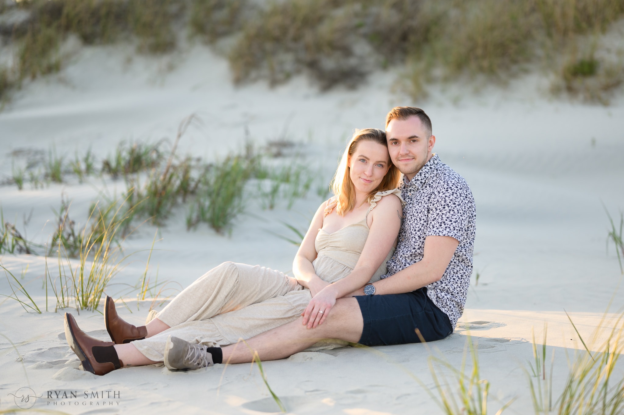 Just engaged couple sitting together by the dunes - Inlet Point Plantation - Little River