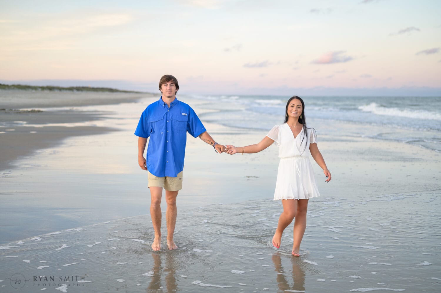 Boyfriend and girlfriend walking down the beach - Huntington Beach State Park