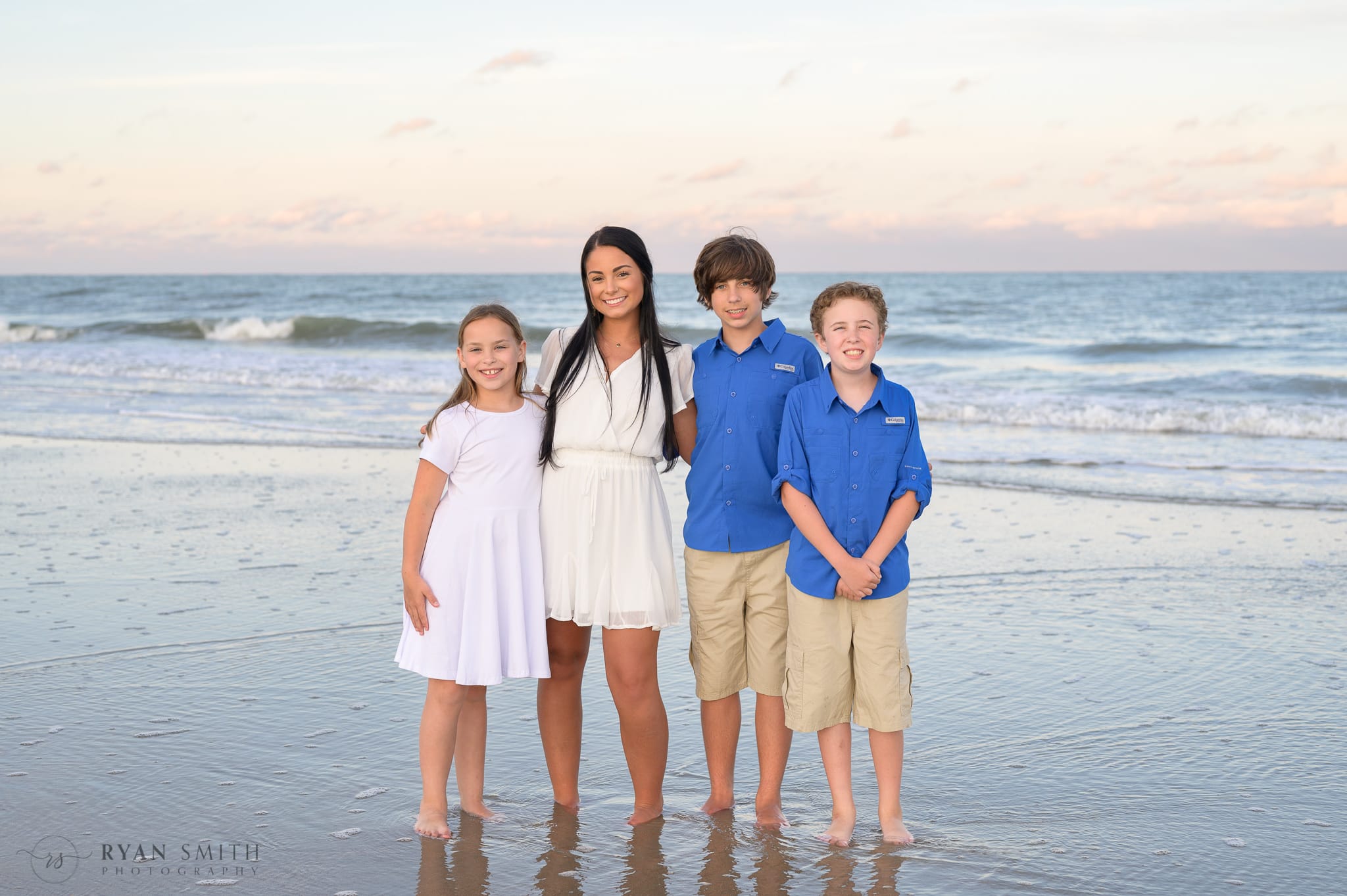 Kids standing by the ocean at sunset - Huntington Beach State Park