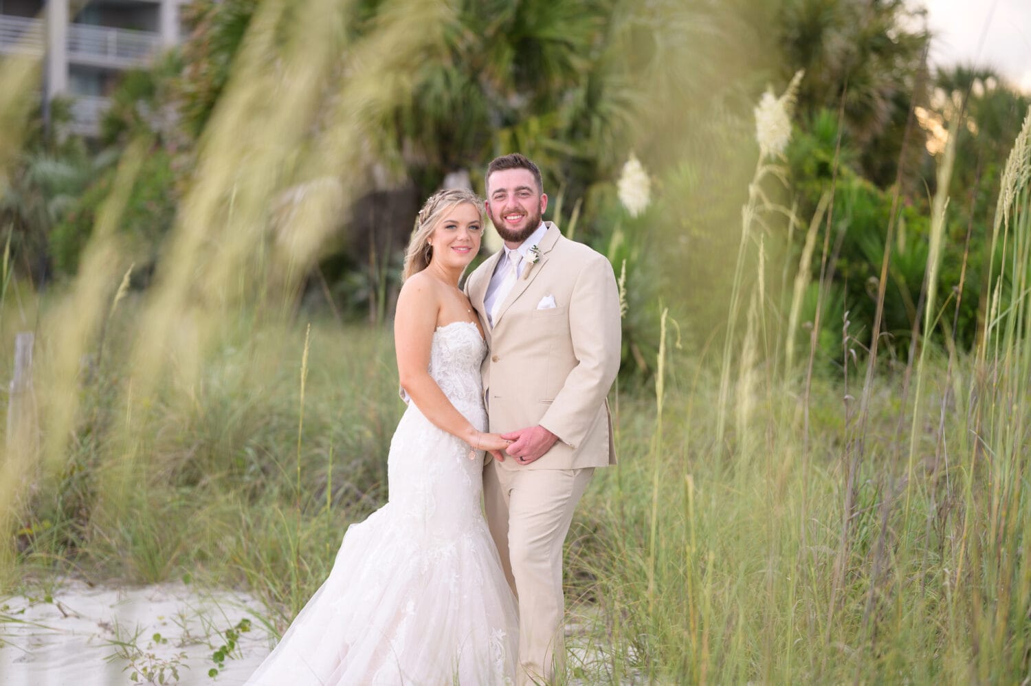 Bride and groom standing behind the sea oats - Hilton - Myrtle Beach Resort