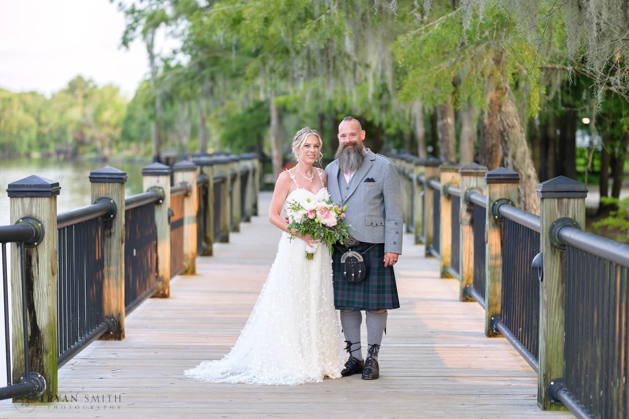 Bride and groom under the moss on the Riverwalk - Conway Riverwalk