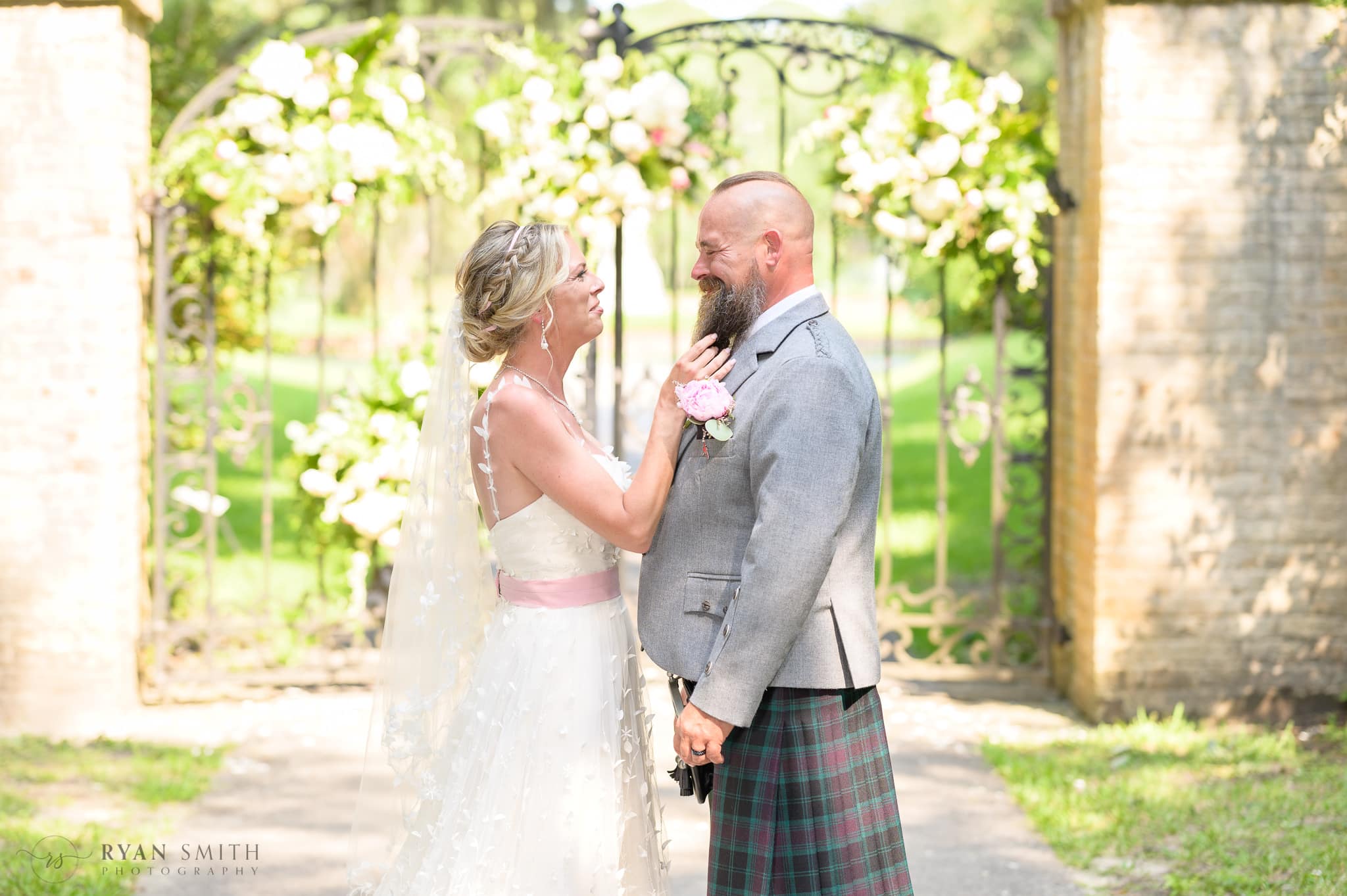 Bride tugging on the groom's beard  - Brookgreen Gardens
